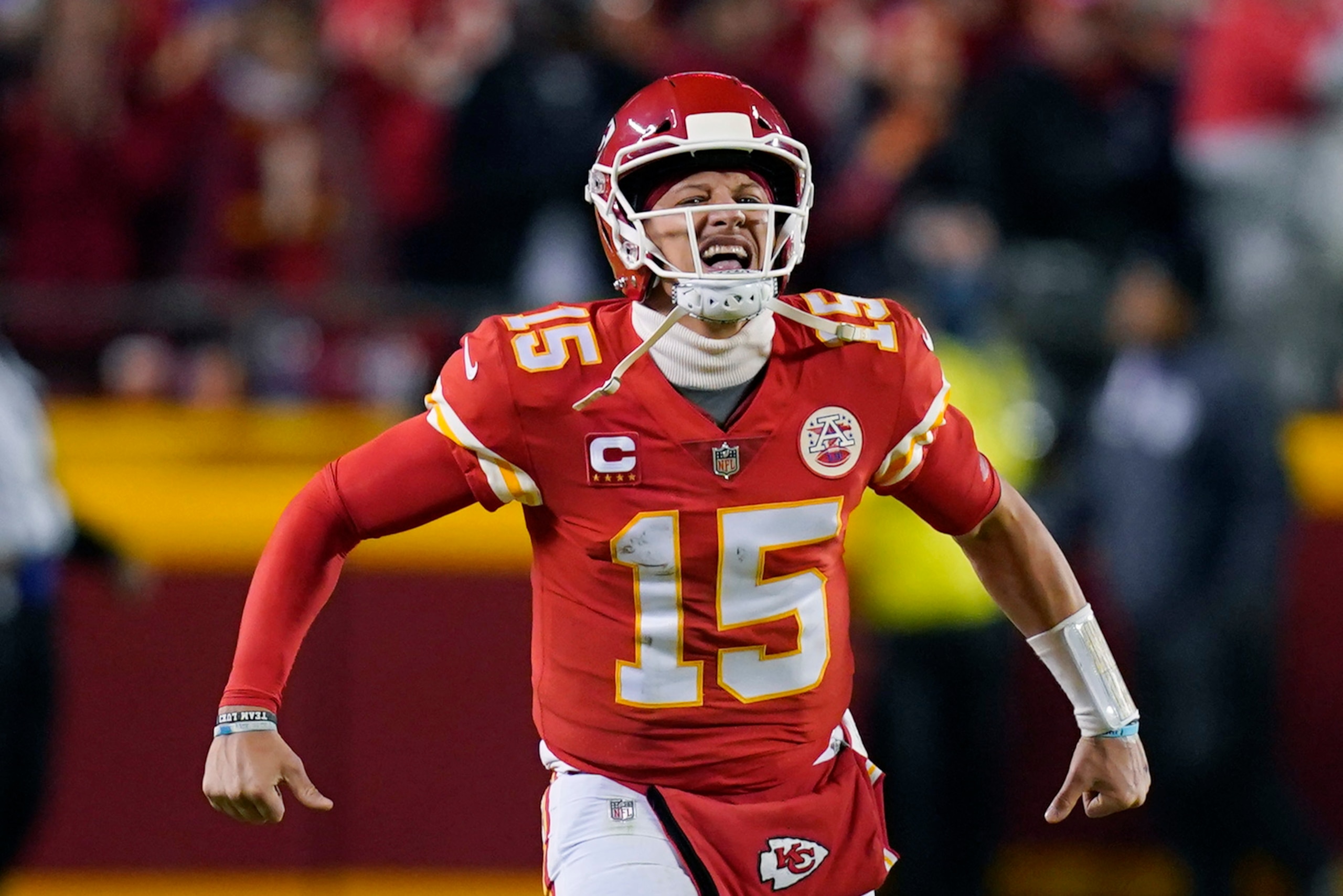Kansas City Chiefs quarterback Patrick Mahomes (15) celebrates after throwing a touchdown pass during the first half of an NFL divisional round playoff football game against the Buffalo Bills, Sunday, Jan. 23, 2022, in Kansas City, Mo. (AP Photo/Ed Zurga)