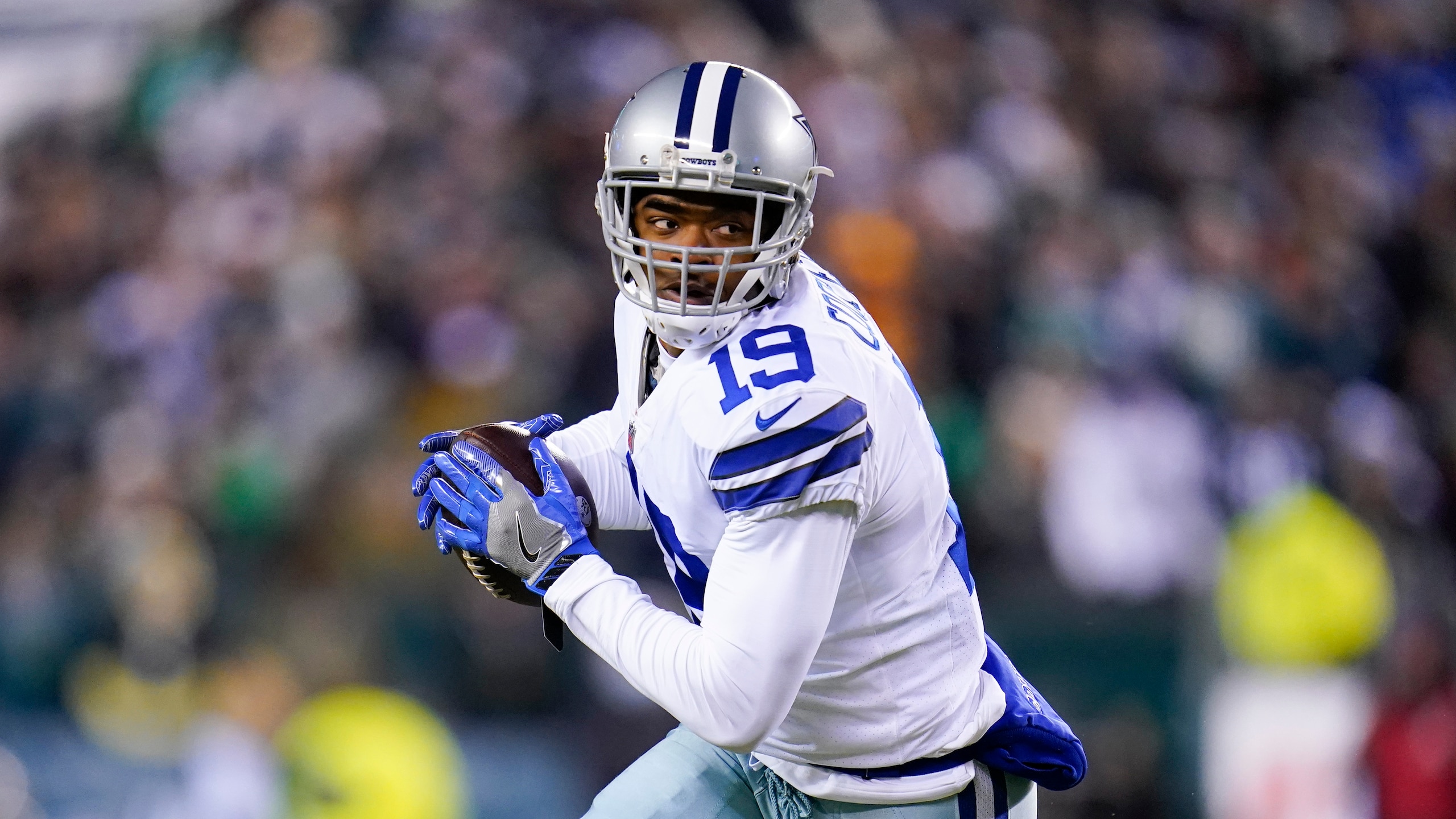 Dallas Cowboys wide receiver Amari Cooper runs with the ball after making a catch against the Philadelphia Eagles during the first half of an NFL football game between the Philadelphia Eagles and the Dallas Cowboys, Saturday, Jan. 8, 2022, in Philadelphia. The Cowboys won 51-26. (AP Photo/Julio Cortez)