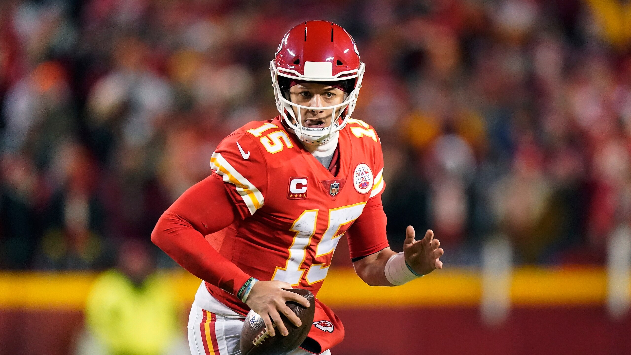 Kansas City Chiefs quarterback Patrick Mahomes (15) scrambles up field during the second half of an NFL divisional round playoff football game against the Buffalo Bills, Sunday, Jan. 23, 2022, in Kansas City, Mo. (AP Photo/Charlie Riedel)