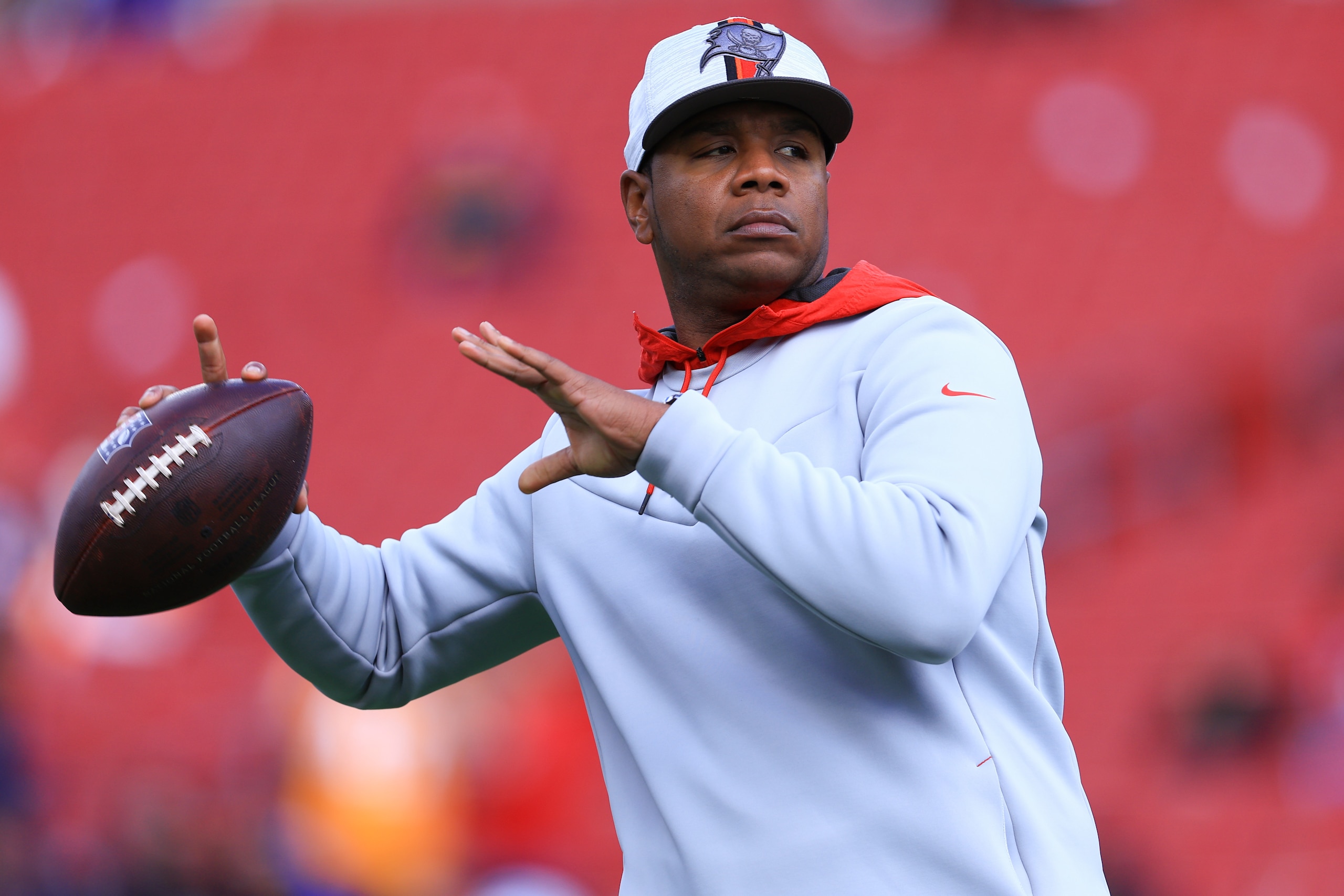 TAMPA, FLORIDA - JANUARY 23: Tampa Bay Buccaneers Offensive Coordinator Byron Leftwich passes the ball to players during warmups before the game against the Los Angeles Rams in the NFC Divisional Playoff game at Raymond James Stadium on January 23, 2022 in Tampa, Florida. (Photo by Mike Ehrmann/Getty Images)