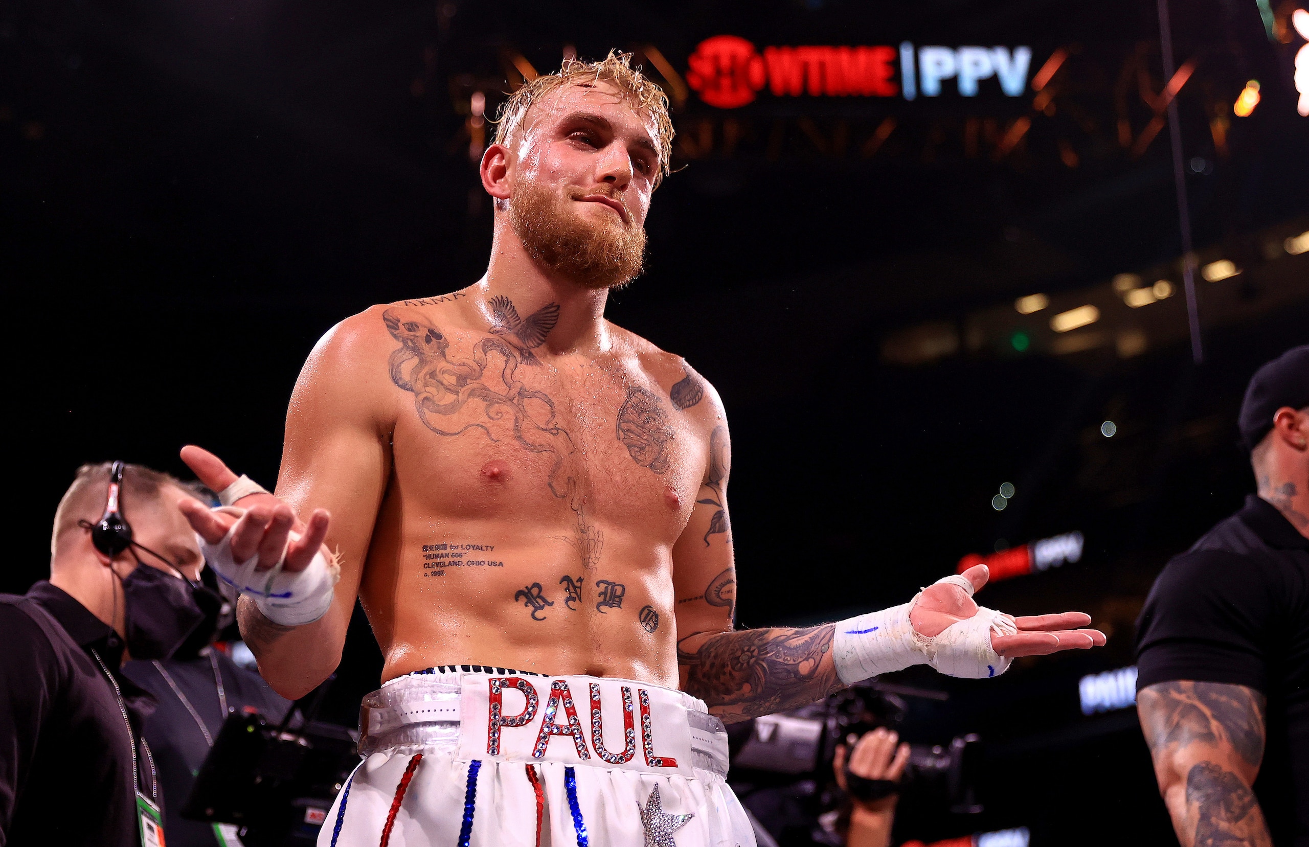 TAMPA, FLORIDA - DECEMBER 18: Jake Paul reacts to knocking out Tyron Woddley in the sixth round during an eight-round cruiserweight bout at the Amalie Arena on December 18, 2021 in Tampa, Florida. (Photo by Mike Ehrmann/Getty Images) TAMPA, FLORIDA - DECEMBER 18: Jake Paul reacts to knocking out Tyron Woddley in the sixth round during an eight-round cruiserweight bout at the Amalie Arena on December 18, 2021 in Tampa, Florida. (Photo by Mike Ehrmann/Getty Images)