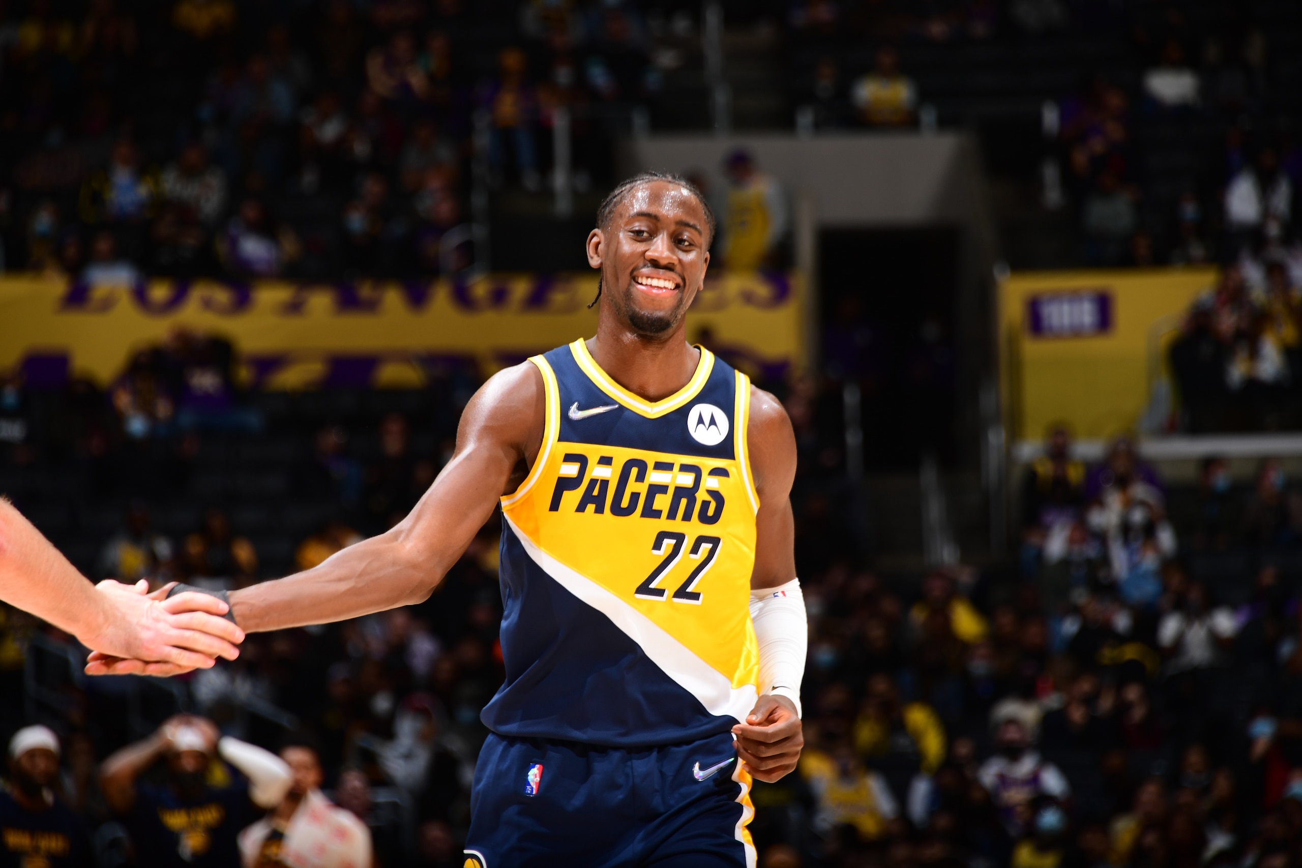 LOS ANGELES, CA - JANUARY 19: Caris LeVert #22 of the Indiana Pacers high fives a teammate during the game against the Los Angeles Lakers on January 19, 2022 at Crypto.Com Arena in Los Angeles, California. NOTE TO USER: User expressly acknowledges and agrees that, by downloading and/or using this Photograph, user is consenting to the terms and conditions of the Getty Images License Agreement. Mandatory Copyright Notice: Copyright 2022 NBAE (Photo by Adam Pantozzi/NBAE via Getty Images)