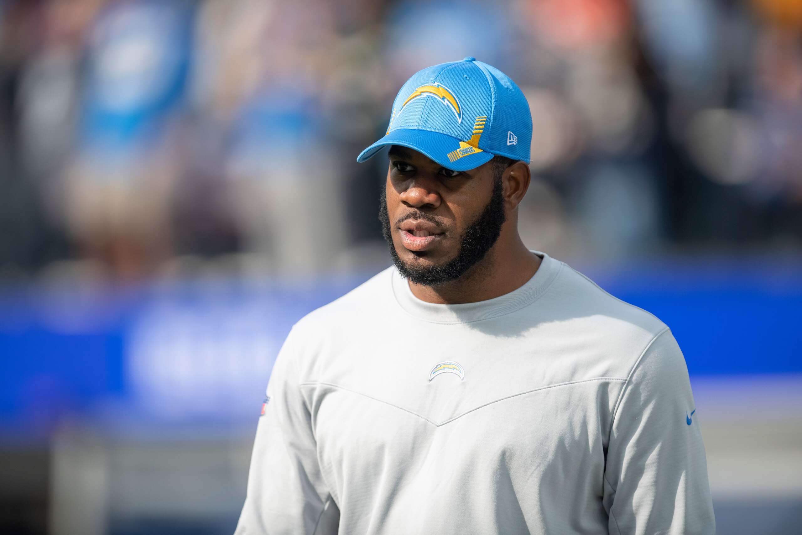 Los Angeles Chargers tight ends coach Kevin Koger walks on the field before an NFL football game against the Denver Broncos Sunday, Jan. 2, 2022, in Inglewood, Calif. (AP Photo/Kyusung Gong)