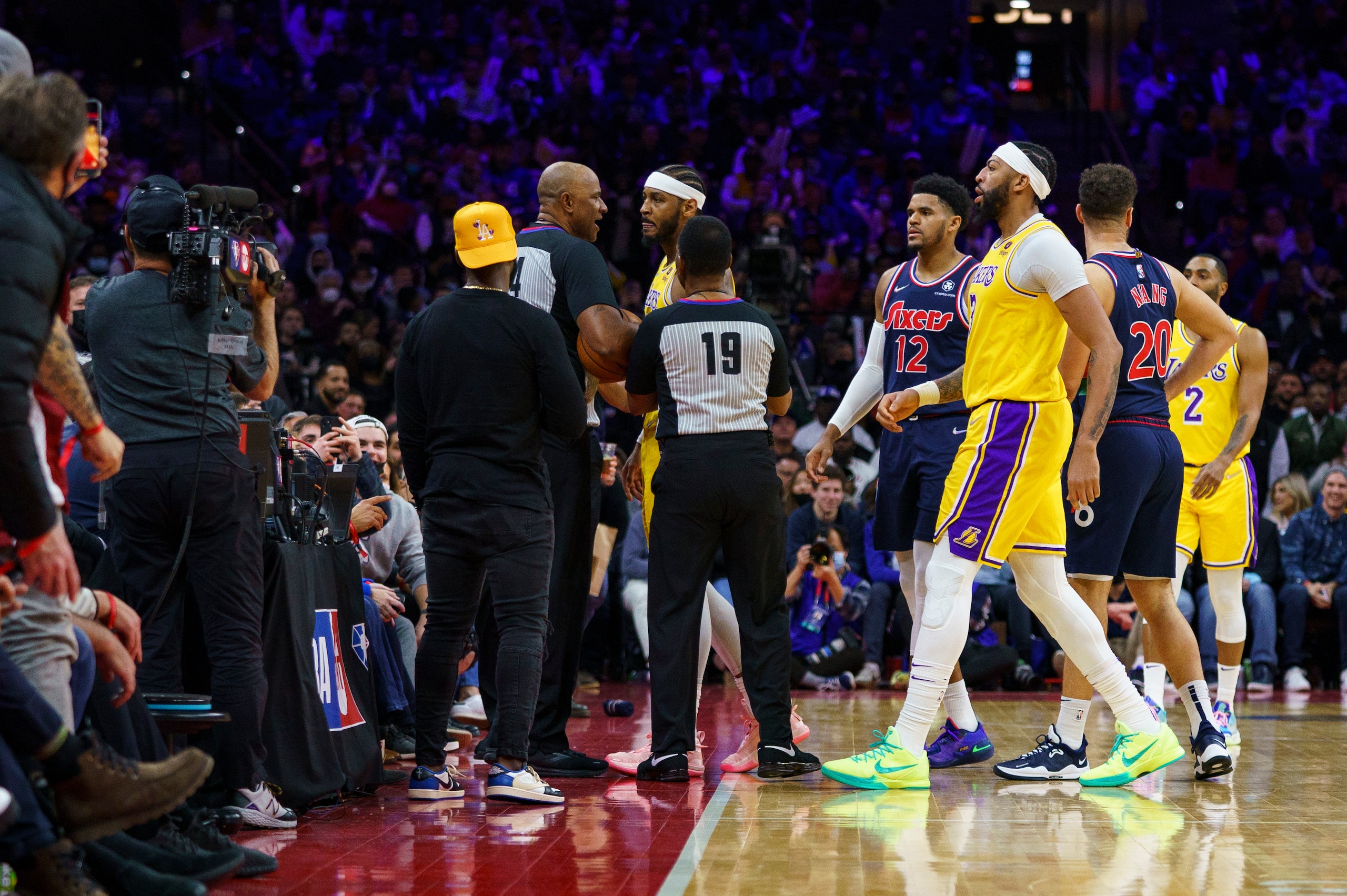 Los Angeles Lakers' Carmelo Anthony, center, gets held back by the officials after having words with a fan during the second half of an NBA basketball game, Thursday, Jan. 27, 2022, in Philadelphia. The 76ers won 105-87. (AP Photo/Chris Szagola) Los Angeles Lakers' Carmelo Anthony, center, gets held back by the officials after having words with a fan during the second half of an NBA basketball game, Thursday, Jan. 27, 2022, in Philadelphia. The 76ers won 105-87. (AP Photo/Chris Szagola)