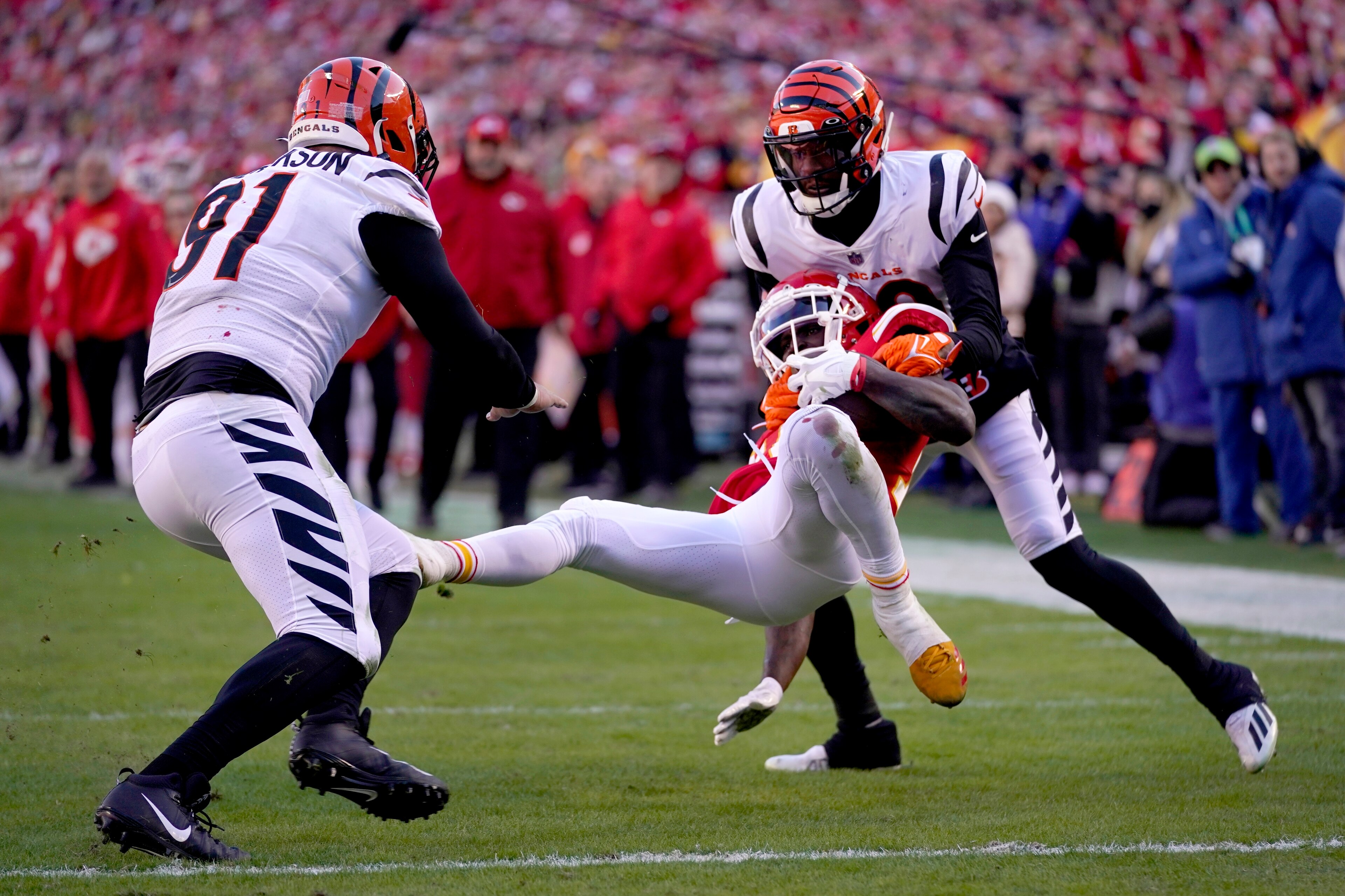 Kansas City Chiefs wide receiver Tyreek Hill, center, catches a pass short of the end zone between Cincinnati Bengals defensive end Trey Hendrickson (91) and cornerback Eli Apple, right, during the first half of the AFC championship NFL football game, Sunday, Jan. 30, 2022, in Kansas City, Mo. (AP Photo/Paul Sancya) Kansas City Chiefs wide receiver Tyreek Hill, center, catches a pass short of the end zone between Cincinnati Bengals defensive end Trey Hendrickson (91) and cornerback Eli Apple, right, during the first half of the AFC championship NFL football game, Sunday, Jan. 30, 2022, in Kansas City, Mo. (AP Photo/Paul Sancya)