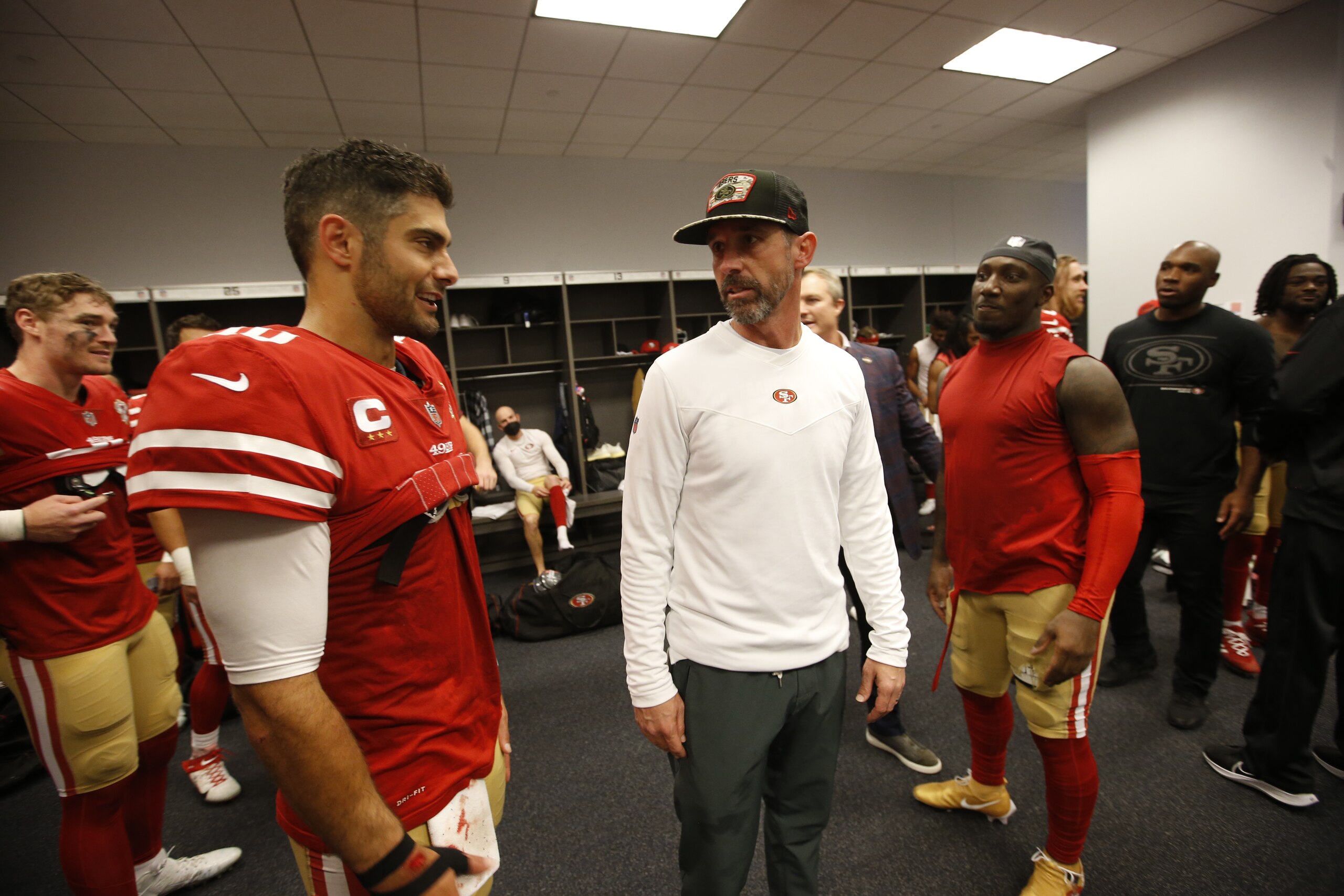ARLINGTON, TX - JANUARY 16: Jimmy Garoppolo #10 and Head Coach Kyle Shanahan of the San Francisco 49ers in the locker room after the NFC Wild Card Playoff game against the Dallas Cowboys at AT&T Stadium on January 16, 2022 in Arlington, Texas. The 49ers defeated the Cowboys 23-17. (Photo by Michael Zagaris/San Francisco 49ers/Getty Images)