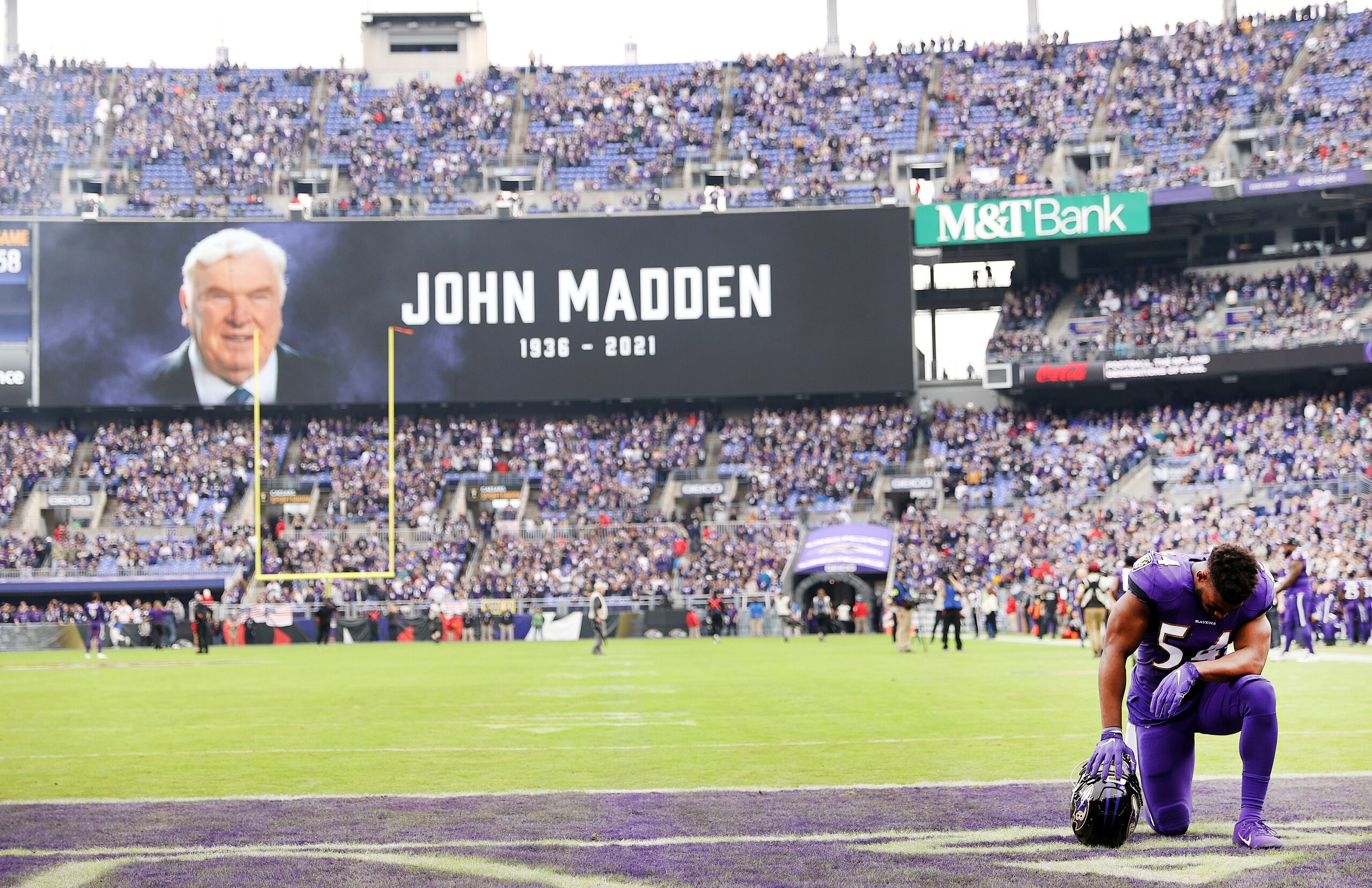 BALTIMORE, MARYLAND - JANUARY 02: Tyus Bowser #54 of the Baltimore Ravens kneels in the endzone before a moment of silence is recognized for former NFL coach John Madden before the game against the Los Angeles Rams at M&T Bank Stadium on January 02, 2022 in Baltimore, Maryland. (Photo by Patrick Smith/Getty Images)