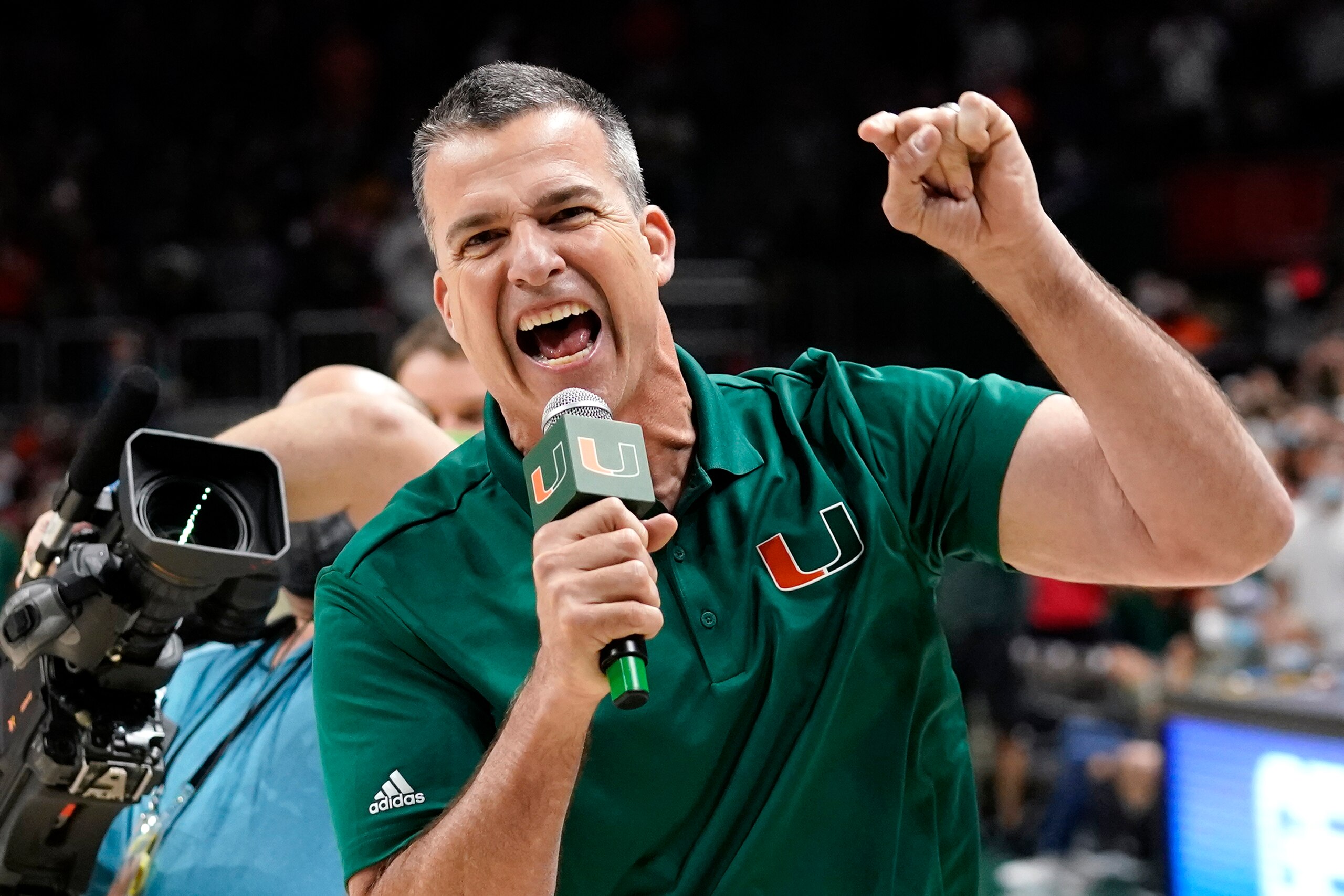 Miami head football coach Mario Cristobal encourages the crowd during the second half of an NCAA college basketball game between Miami and Florida State, Saturday, Jan. 22, 2022, in Coral Gables, Fla. Florida State won 61-60. (AP Photo/Lynne Sladky)