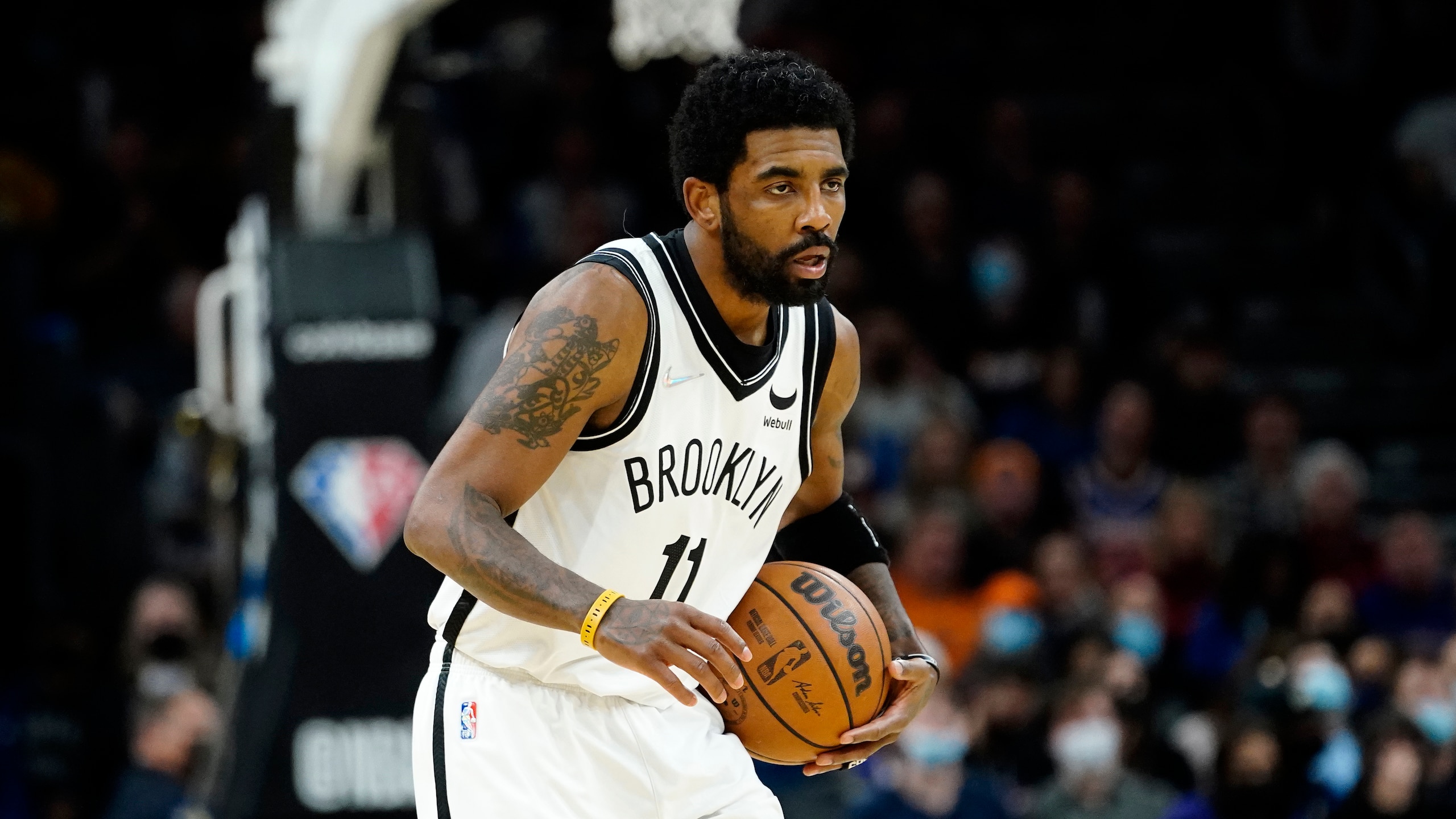 Brooklyn Nets guard Kyrie Irving (11) looks to pass against the Phoenix Suns during the first half of an NBA basketball game, Tuesday, Feb. 1, 2022, in Phoenix. (AP Photo/Matt York)