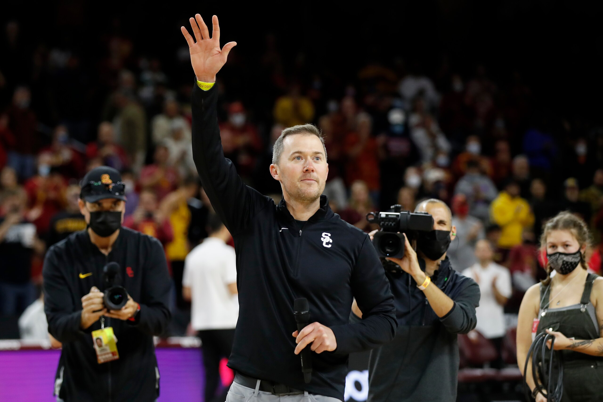 Southern California head football coach Lincoln Riley is introduced to the basketball fans during the first half of an NCAA college basketball game against Long Beach State in Los Angeles, Sunday, Dec. 12, 2021. (AP Photo/Alex Gallardo)