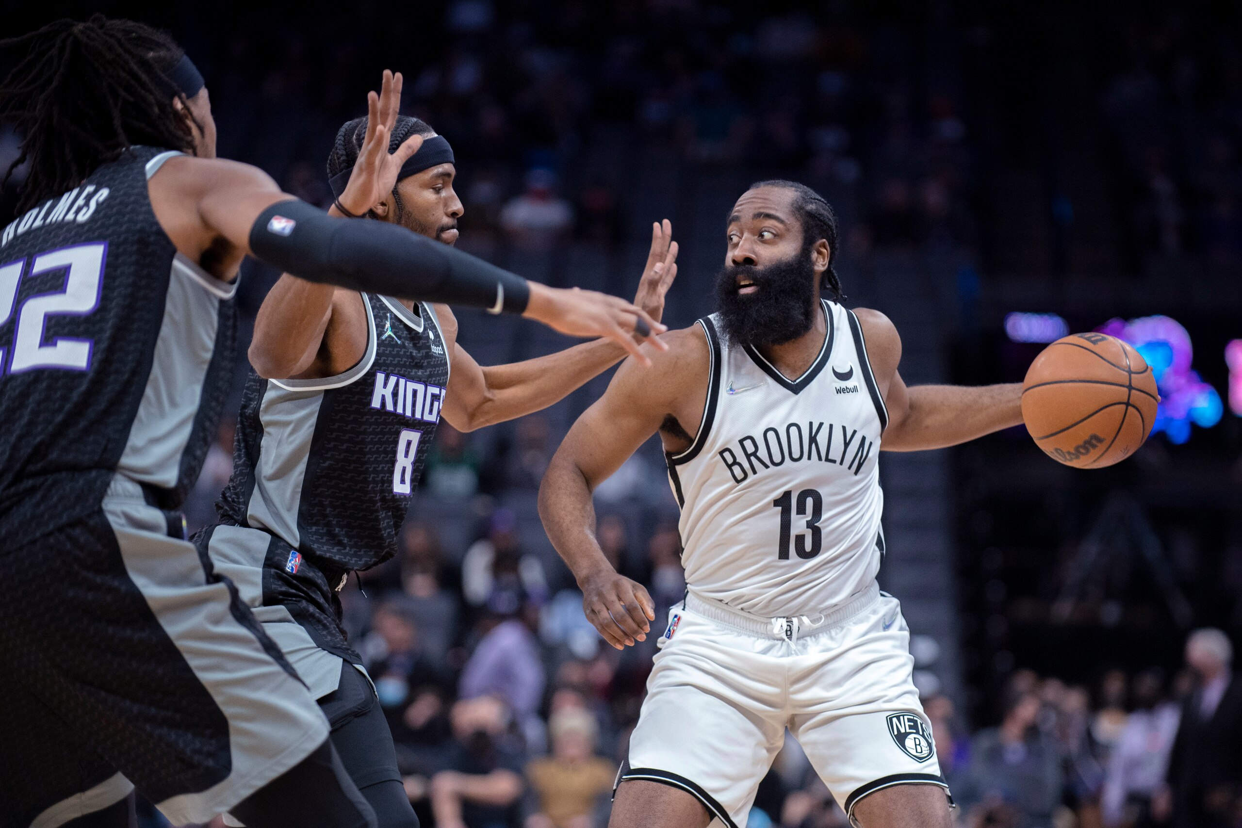 Brooklyn Nets guard James Harden (13) is double-teamed by Sacramento Kings forward Maurice Harkless (8) and center Richaun Holmes (22) during the first quarter of an NBA basketball game in Sacramento, Calif., Wednesday, Feb. 2, 2022. (AP Photo/José Luis Villegas)