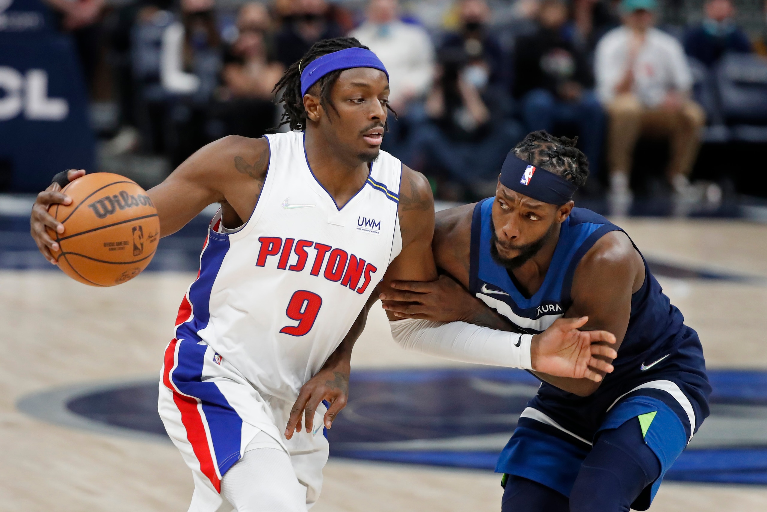 Detroit Pistons forward Jerami Grant (9) goes around Minnesota Timberwolves guard Patrick Beverly in the fourth quarter of an NBA basketball game, Sunday, Feb. 6, 2022, in Minneapolis. The Timberwolves won 118-105. (AP Photo/Bruce Kluckhohn)
