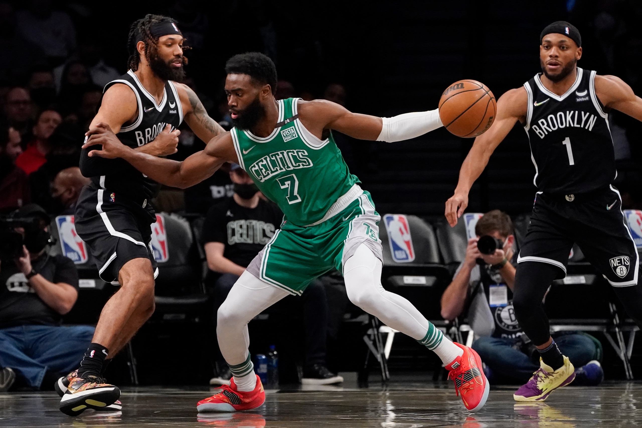 Boston Celtics guard Jaylen Brown (7) drives against Brooklyn Nets guard DeAndre' Bembry, left, during the first half of an NBA basketball game, Tuesday, Feb. 8, 2022, in New York. (AP Photo/John Minchillo) Boston Celtics guard Jaylen Brown (7) drives against Brooklyn Nets guard DeAndre' Bembry, left, during the first half of an NBA basketball game, Tuesday, Feb. 8, 2022, in New York. (AP Photo/John Minchillo)
