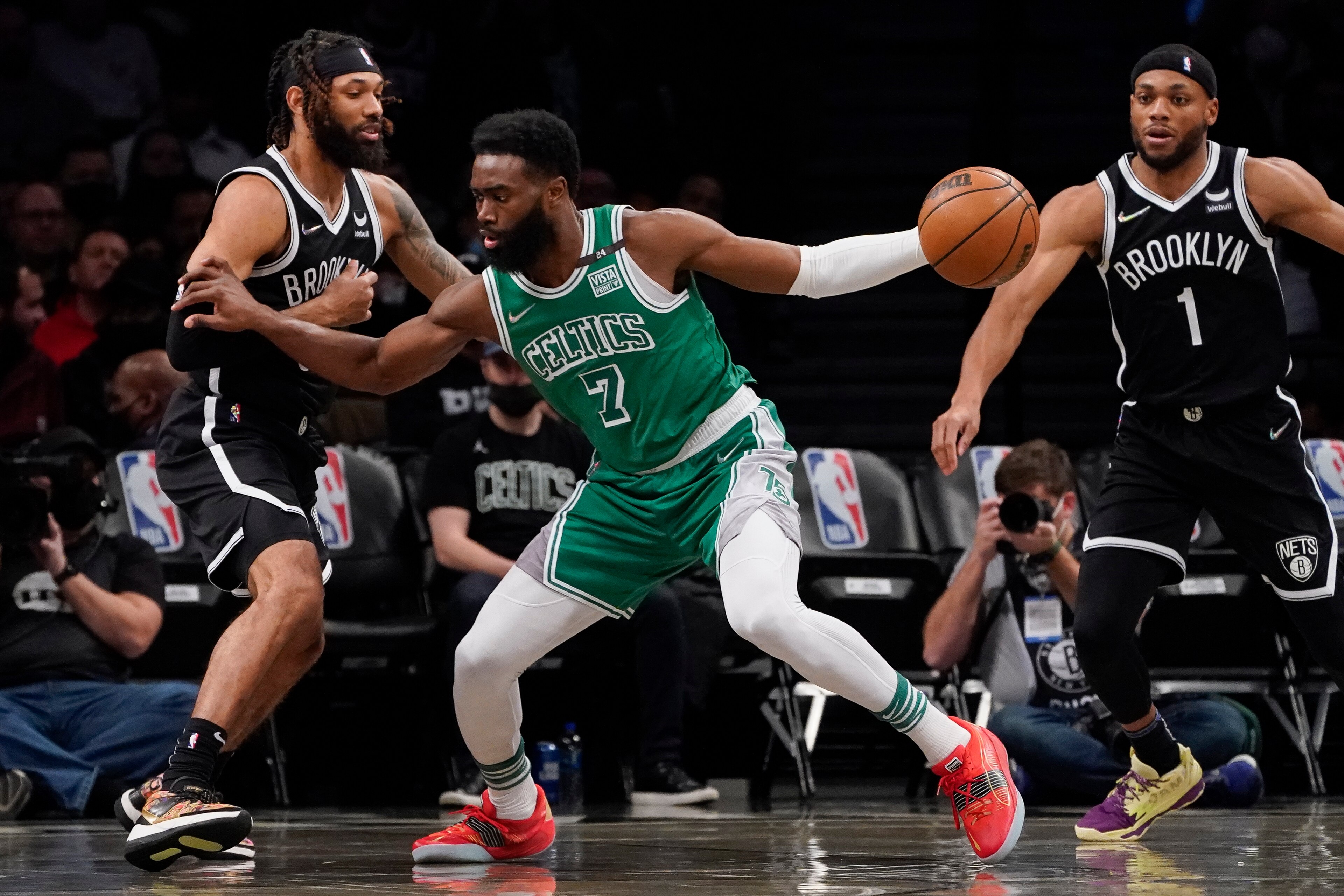 Boston Celtics guard Jaylen Brown (7) drives against Brooklyn Nets guard DeAndre' Bembry, left, during the first half of an NBA basketball game, Tuesday, Feb. 8, 2022, in New York. (AP Photo/John Minchillo)