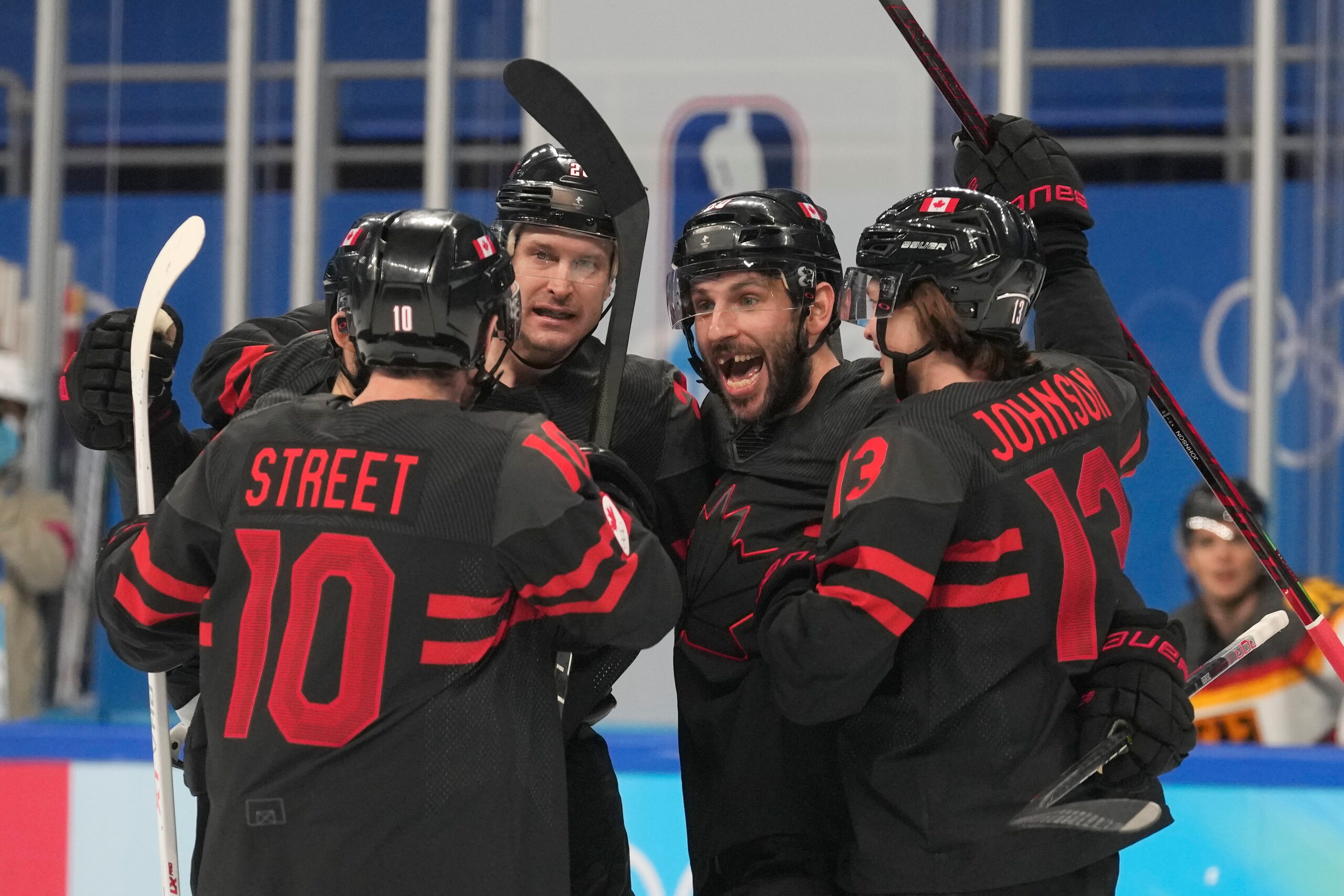Canada's Ben Street (10) is congratulated after scoring a goal against Germany during a preliminary round men's hockey game at the 2022 Winter Olympics, Thursday, Feb. 10, 2022, in Beijing. (AP Photo/Petr David Josek)