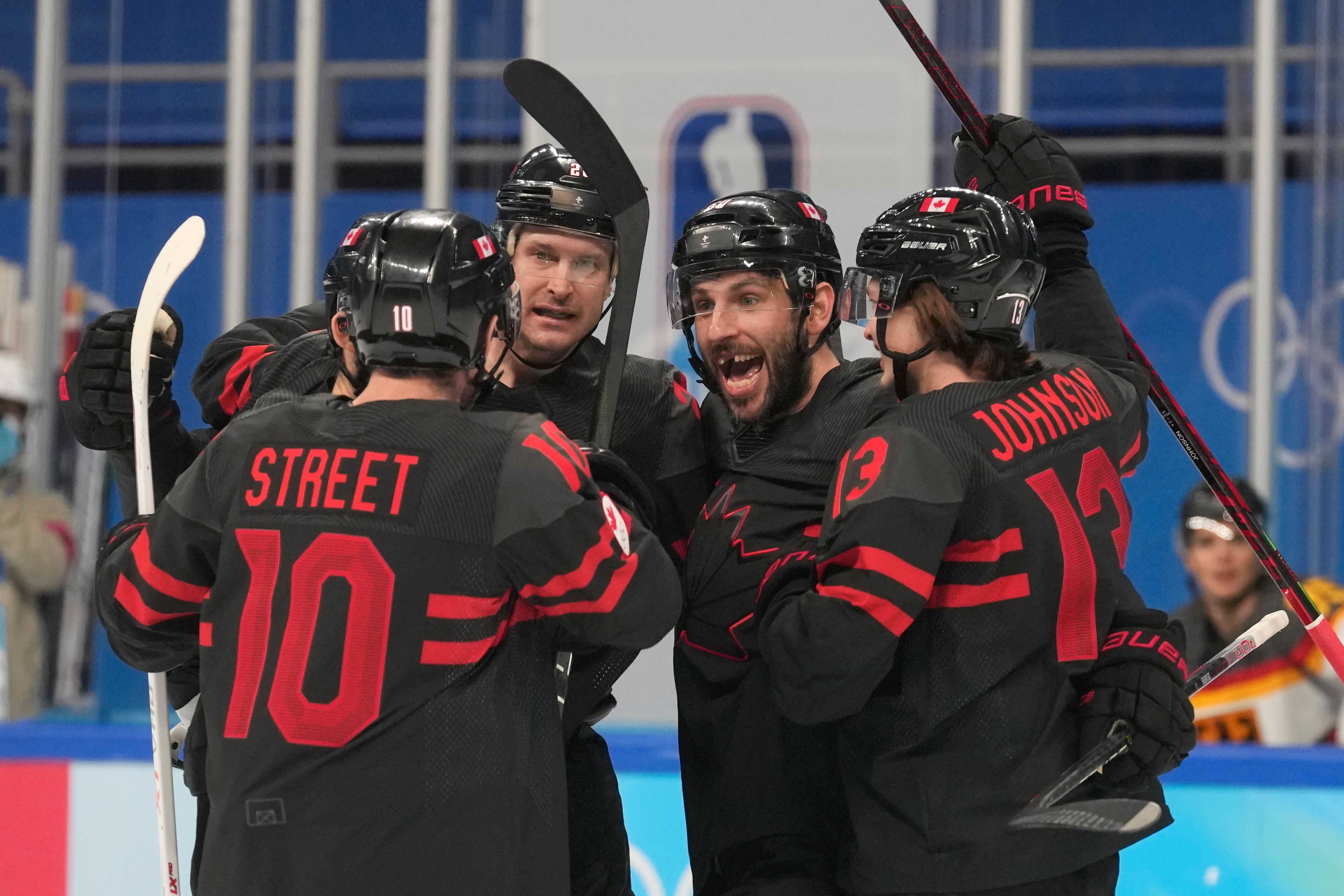 Canada's Ben Street (10) is congratulated after scoring a goal against Germany during a preliminary round men's hockey game at the 2022 Winter Olympics, Thursday, Feb. 10, 2022, in Beijing. (AP Photo/Petr David Josek)