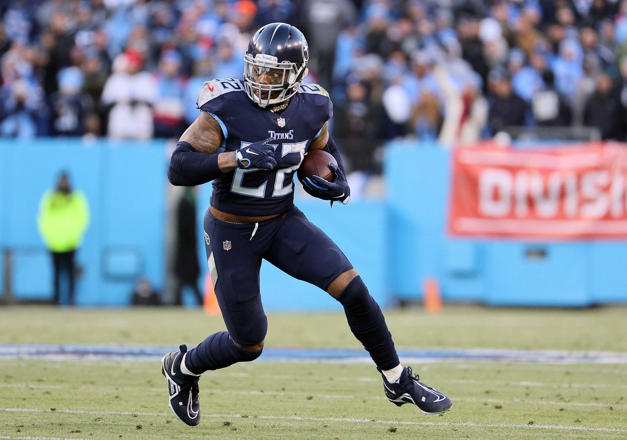NASHVILLE, TENNESSEE - JANUARY 22: Derrick Henry #22 of the Tennessee Titans carries the ball against the Cincinnati Bengals during the first half in the AFC Divisional Playoff game at Nissan Stadium on January 22, 2022 in Nashville, Tennessee. (Photo by Andy Lyons/Getty Images)