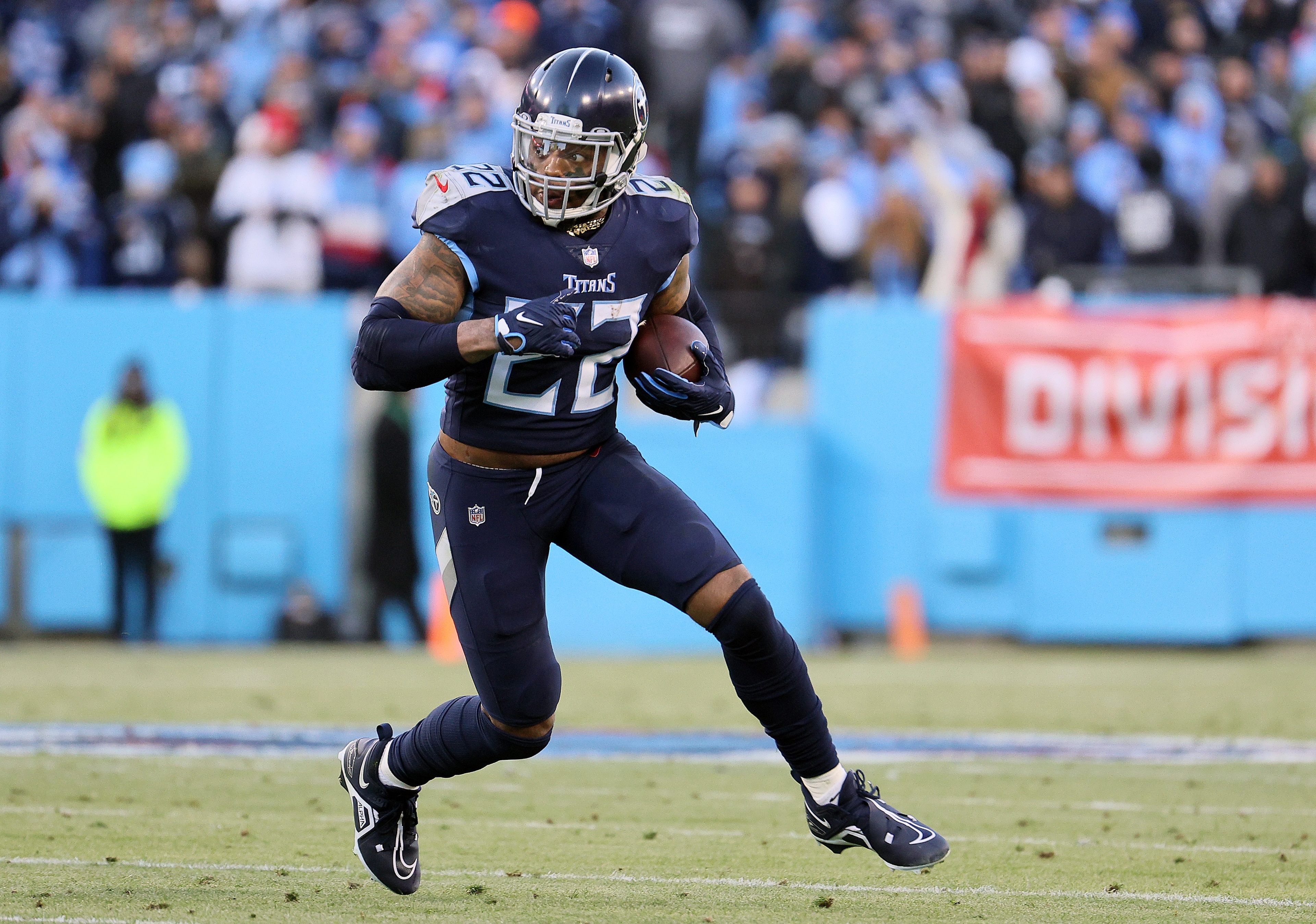 NASHVILLE, TENNESSEE - JANUARY 22: Derrick Henry #22 of the Tennessee Titans carries the ball against the Cincinnati Bengals during the first half in the AFC Divisional Playoff game at Nissan Stadium on January 22, 2022 in Nashville, Tennessee. (Photo by Andy Lyons/Getty Images)