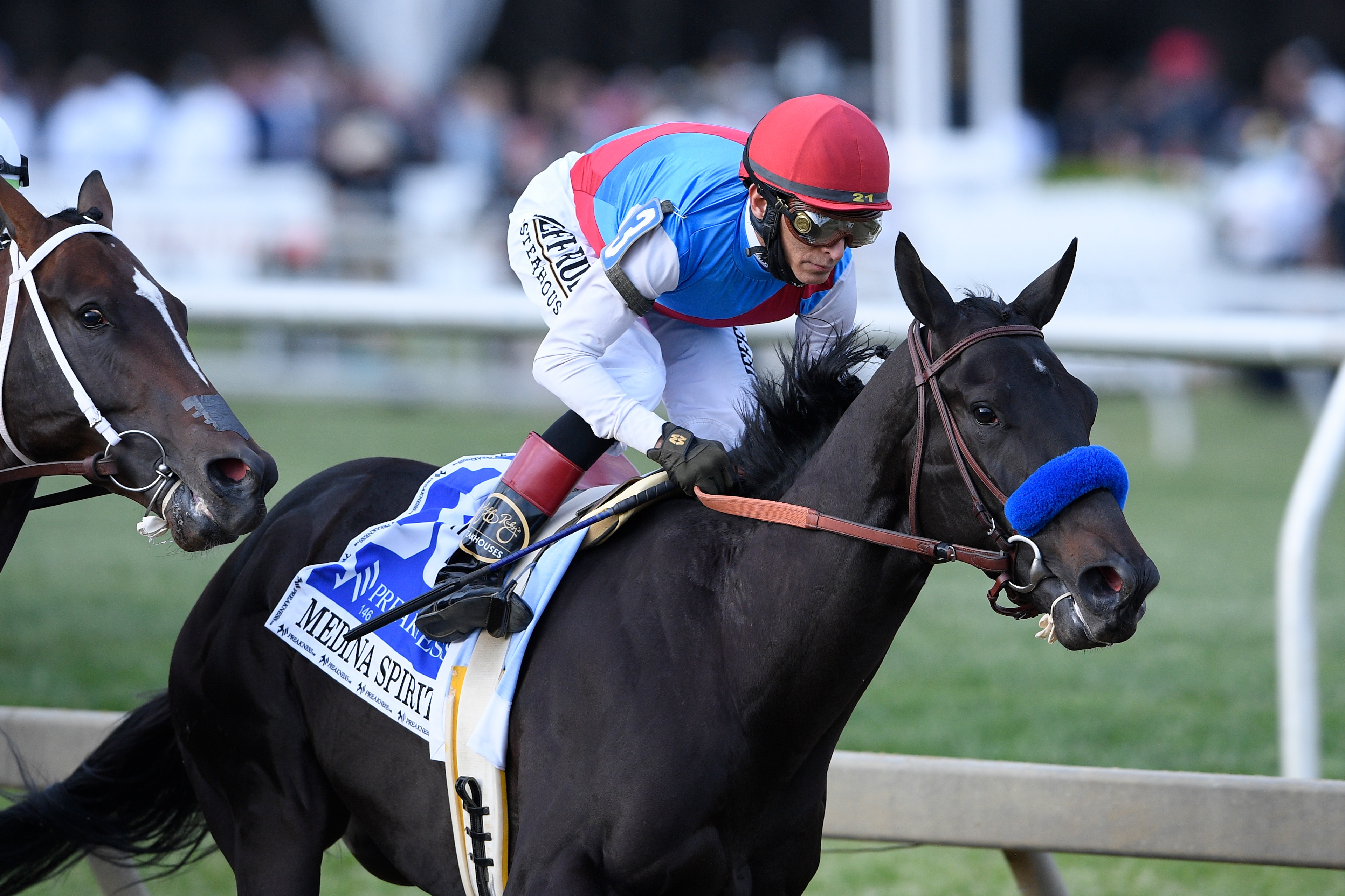 John Velazquez atop Medina Spirit runs in the Preakness Stakes horse race at Pimlico Race Course, Saturday, May 15, 2021, in Baltimore. (AP Photo/Nick Wass)