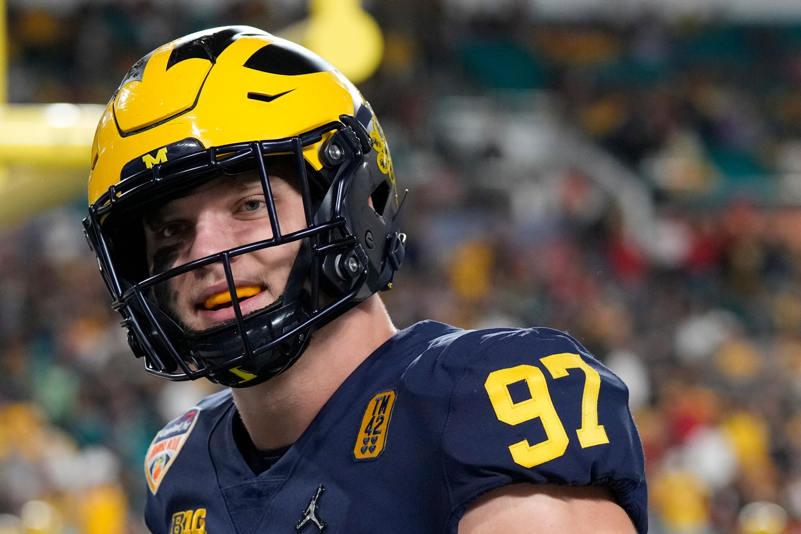 Michigan defensive end Aidan Hutchinson watches during warm ups before the Orange Bowl NCAA College Football Playoff semifinal game against Georgia, Friday, Dec. 31, 2021, in Miami Gardens, Fla. (AP Photo/Rebecca Blackwell)