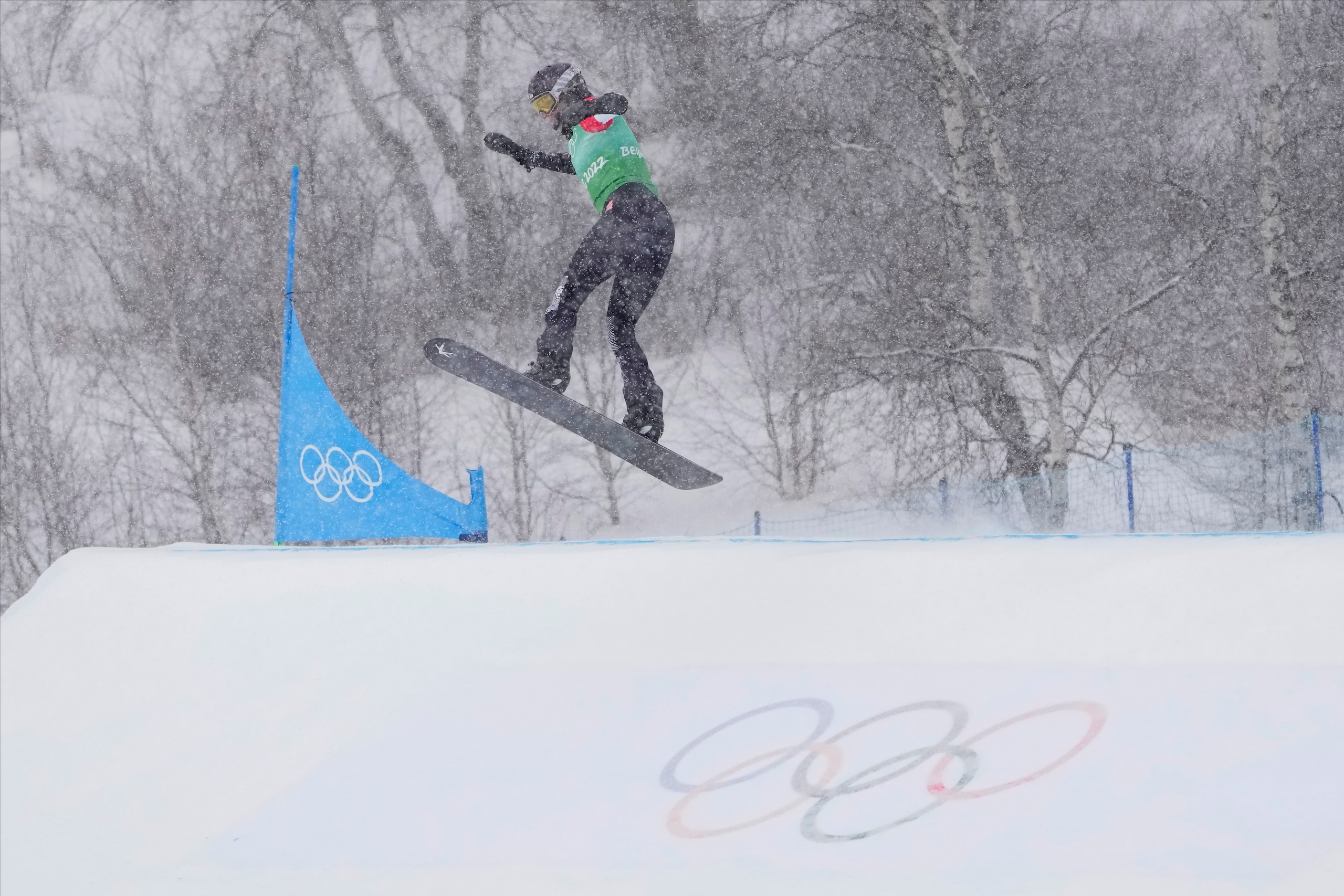 United States' Lindsey Jacobellis leads the pack during the mixed team snowboard cross finals at the 2022 Winter Olympics, Saturday, Feb. 12, 2022, in Zhangjiakou, China. (AP Photo/Lee Jin-man)