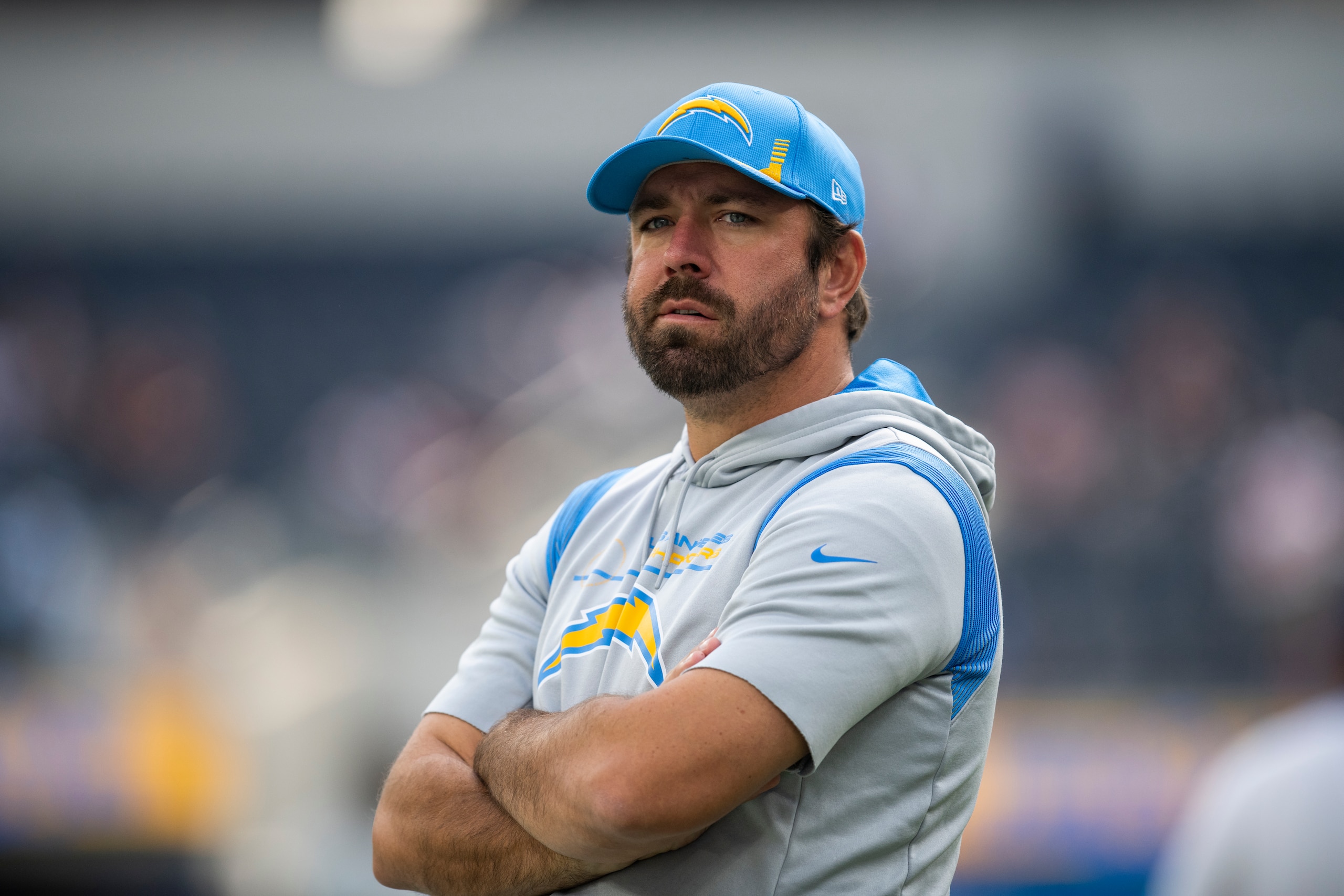 Los Angeles Chargers run game coordinator Frank Smith watches his players warm up before an NFL football game against the Cleveland Browns Sunday, Oct. 10, 2021, in Inglewood, Calif. (AP Photo/Kyusung Gong)
