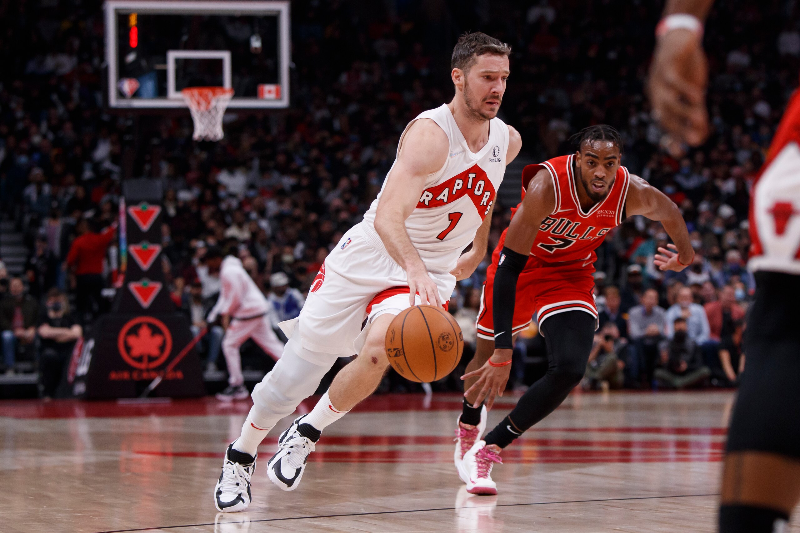 TORONTO, ON - OCTOBER 25: Goran Dragic #1 of the Toronto Raptors drives to the net as Troy Brown Jr. #7 of the Chicago Bulls trails during the first half against the Toronto Raptors at Scotiabank Arena on October 25, 2021 in Toronto, Canada. NOTE TO USER: User expressly acknowledges and agrees that, by downloading and or using this Photograph, user is consenting to the terms and conditions of the Getty Images License Agreement. (Photo by Cole Burston/Getty Images)
