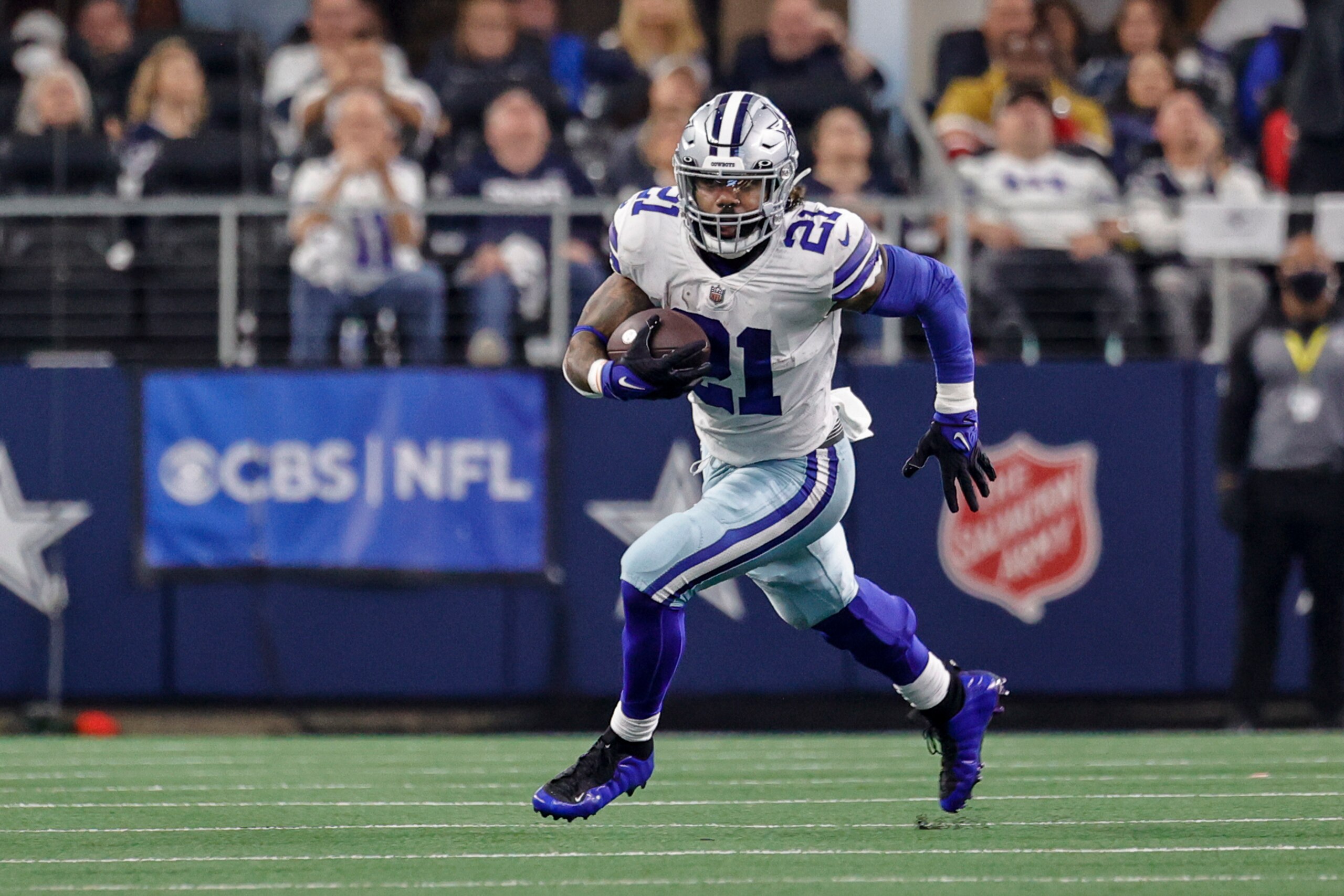 ARLINGTON, TX - JANUARY 16: Dallas Cowboys running back Ezekiel Elliott (21) runs for a first down during the NFC Wild Card game between the Dallas Cowboys and the San Francisco 49ers on January 16, 2022 at AT&T Stadium in Arlington, Texas. (Photo by Matthew Pearce/Icon Sportswire via Getty Images)