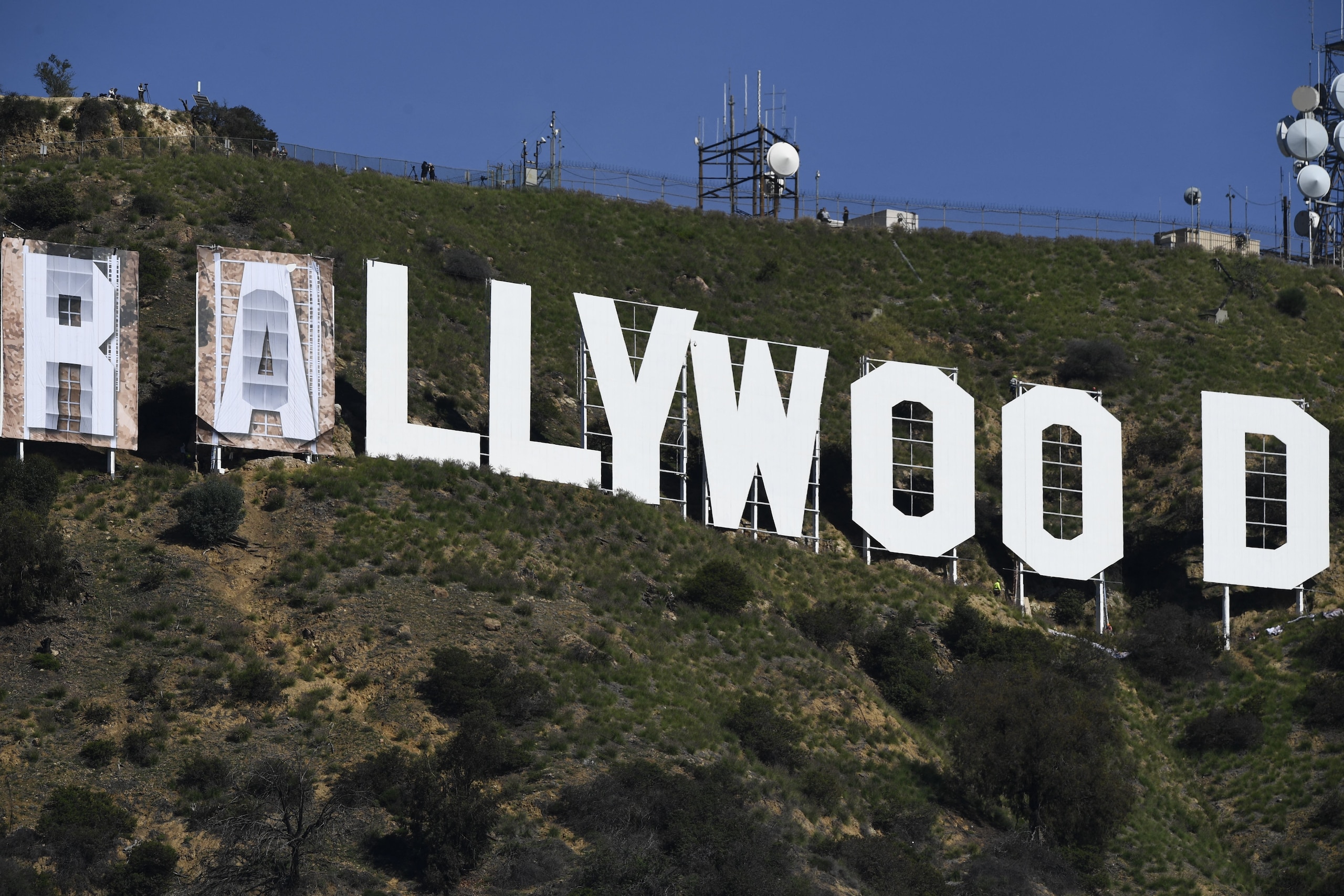 Banners, to read "Rams House", are installed over the Hollywood sign in Los Angeles, California, on February 14, 2022. - The temporary display will be installed to celebrate the Los Angeles Rams victory over the Cincinnati Bengals in Superbowl LVI on February 13. (Photo by Patrick T. FALLON / AFP) (Photo by PATRICK T. FALLON/AFP via Getty Images)