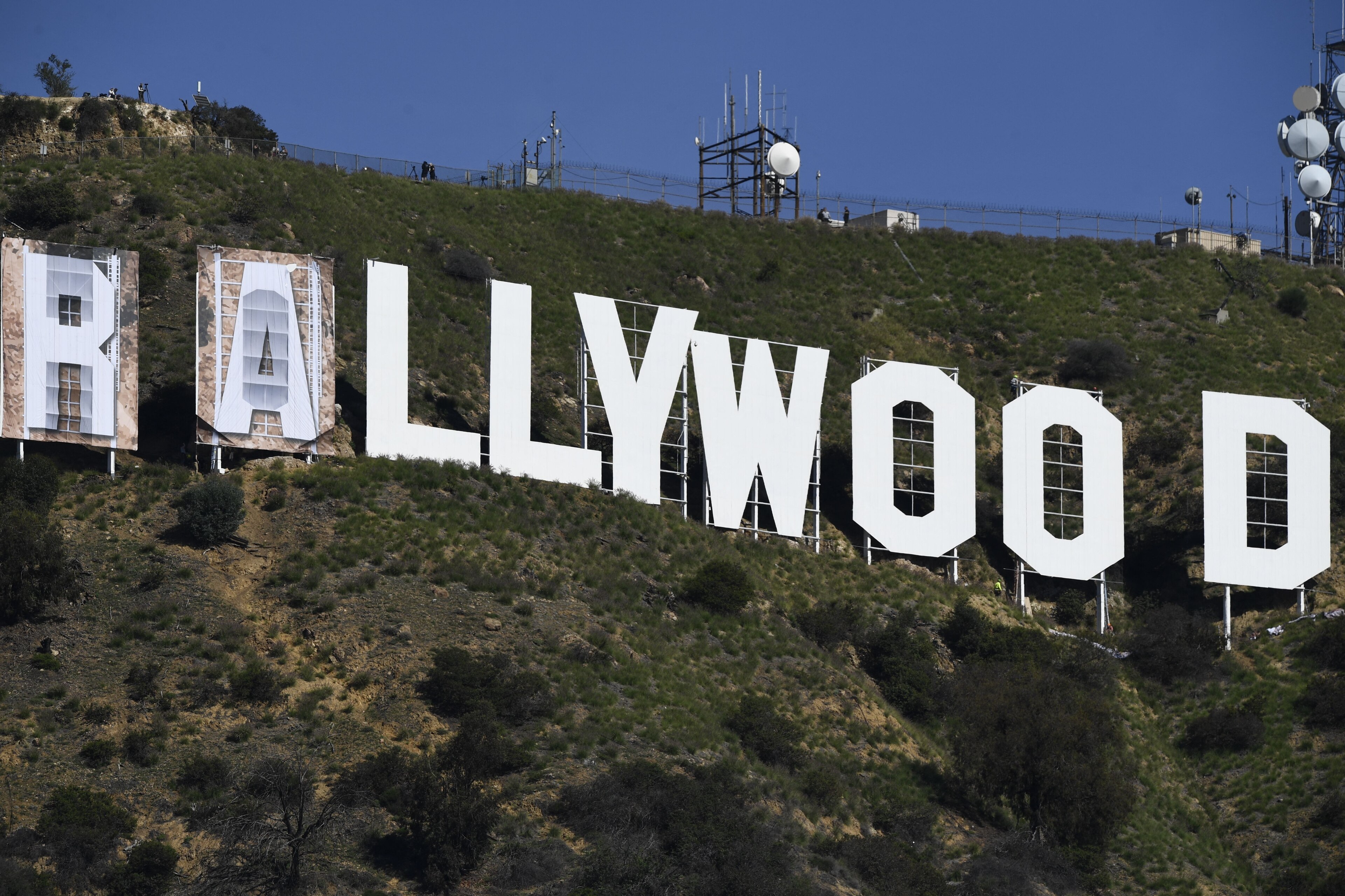 Banners, to read "Rams House", are installed over the Hollywood sign in Los Angeles, California, on February 14, 2022. - The temporary display will be installed to celebrate the Los Angeles Rams victory over the Cincinnati Bengals in Superbowl LVI on February 13. (Photo by Patrick T. FALLON / AFP) (Photo by PATRICK T. FALLON/AFP via Getty Images)