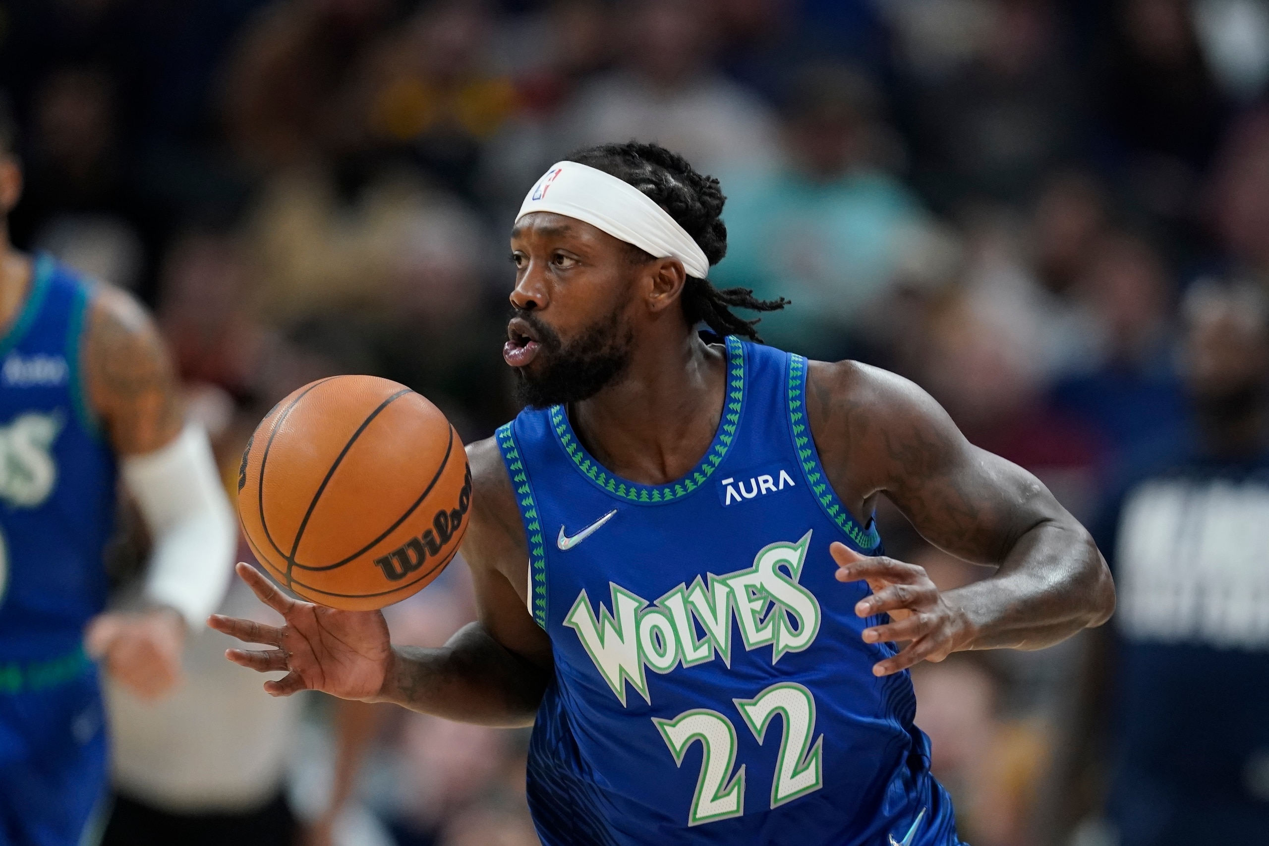 Minnesota Timberwolves' Patrick Beverley (22) dribbles during the first half of an NBA basketball game against the Indiana Pacers, Sunday, Feb. 13, 2022, in Indianapolis. (AP Photo/Darron Cummings)