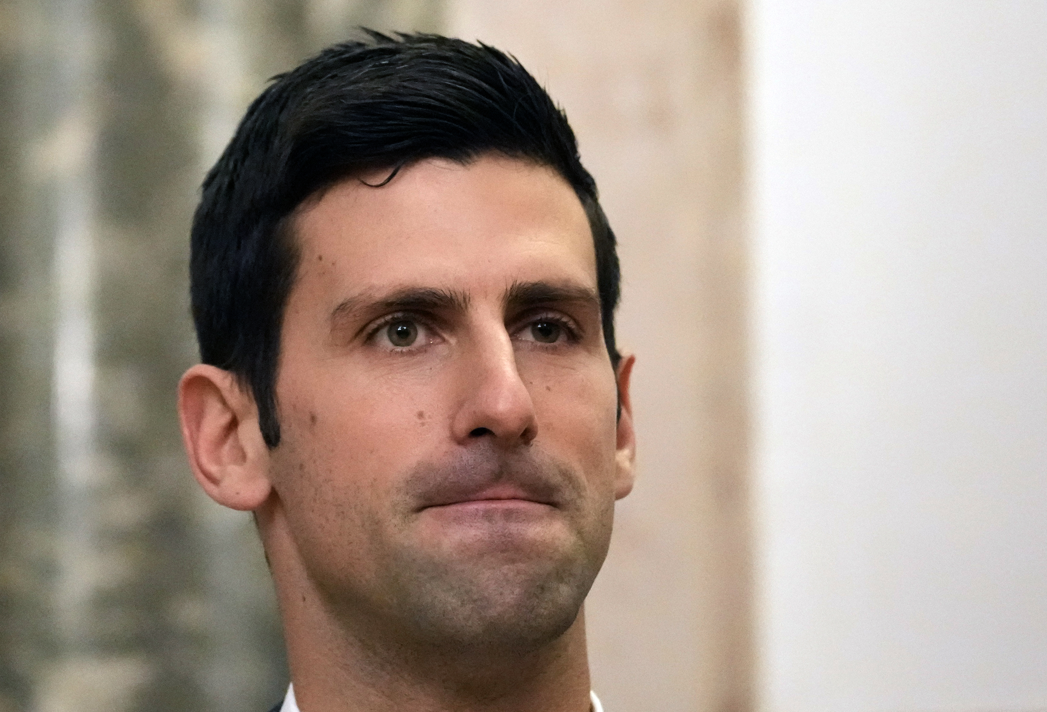 Serbian tennis player Novak Djokovic, left, speaks with Serbia's President Aleksandar Vucic in Belgrade, Serbia, Thursday, Feb. 3, 2022. Serbia's state prosecutors have rejected suggestions that Novak Djokovic used a fake positive test for COVID-19 to try to enter Australia and compete in the Australian Open. (AP Photo/Darko Vojinovic)