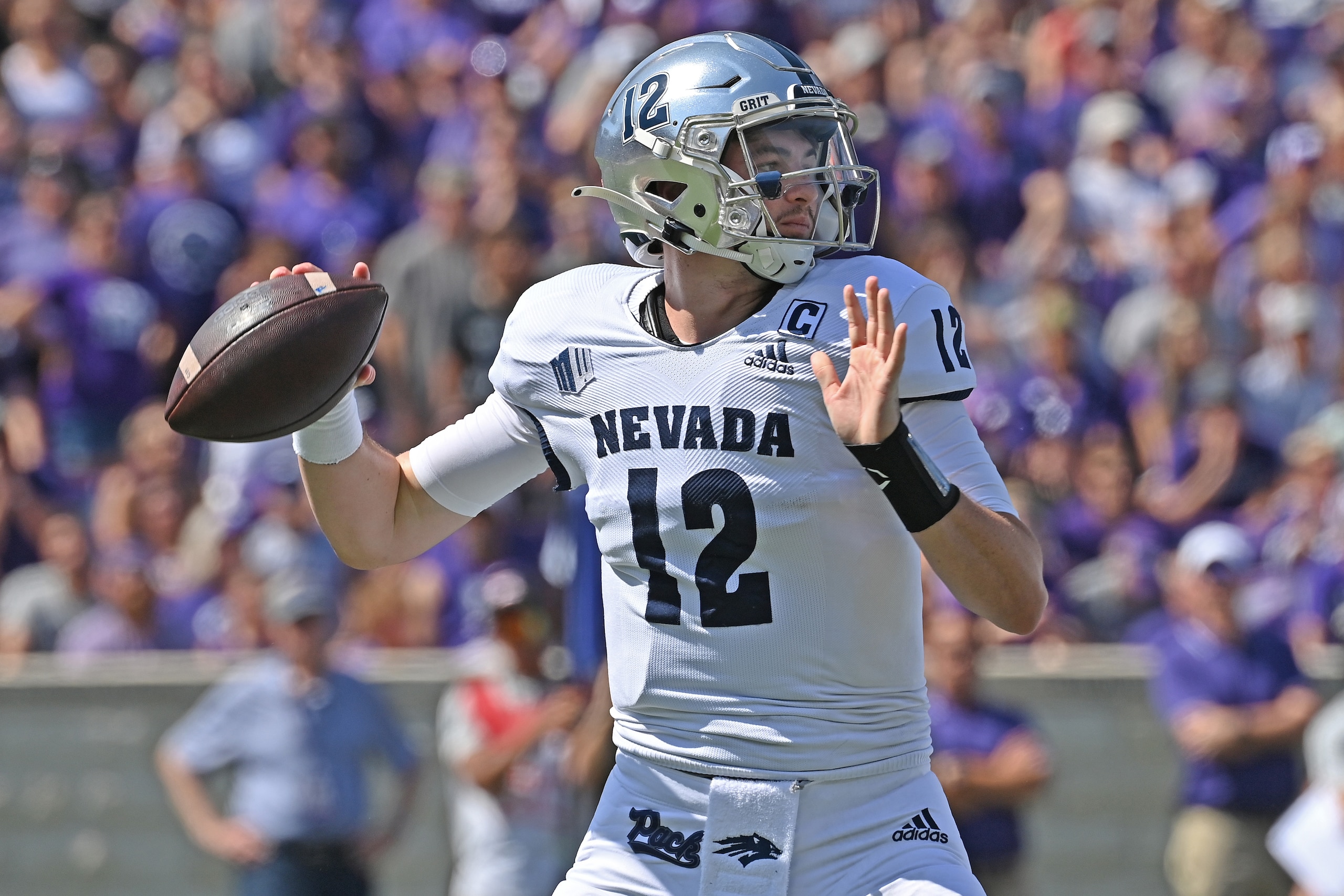 MANHATTAN, KS - SEPTEMBER 18:  Quarterback Carson Strong #12 of the Nevada Wolf Pack drops back to pass  against the Kansas State Wildcats during the first half at Bill Snyder Family Football Stadium on September 18, 2021 in Manhattan, Kansas. (Photo by Peter G. Aiken/Getty Images)