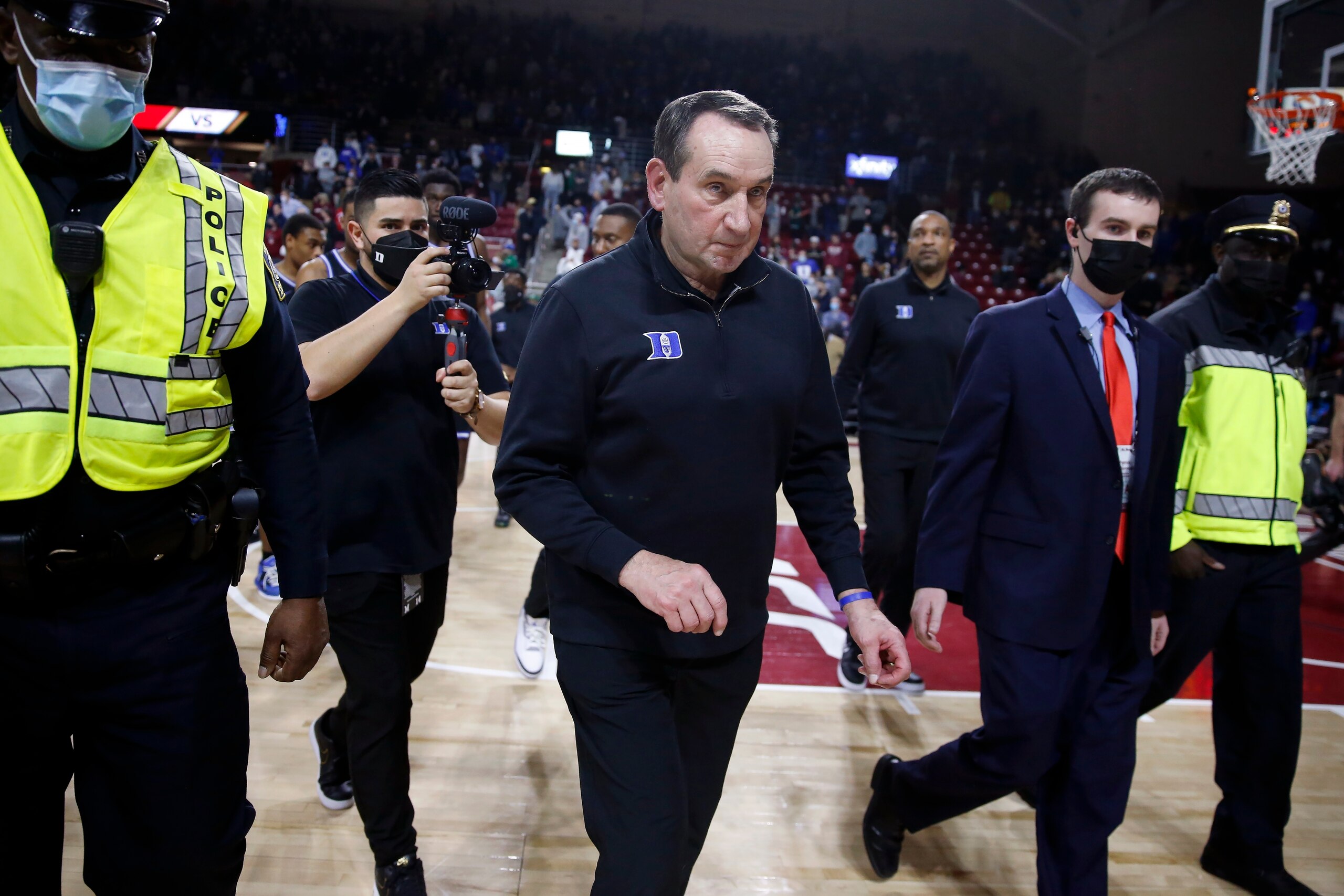 Duke head coach Mike Krzyzewski, center, leaves the court following an NCAA college basketball game against Boston College, Saturday, Feb. 12, 2022, in Boston. (AP Photo/Michael Dwyer)