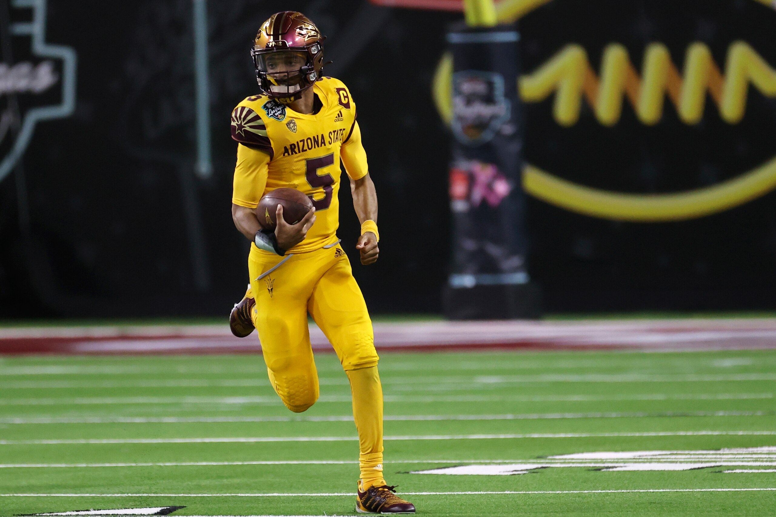 Arizona State quarterback Jayden Daniels (5) runs against Wisconsin during the second half of the Las Vegas Bowl NCAA college football game Thursday, Dec. 30, 2021, in Las Vegas. (AP Photo/L.E. Baskow)