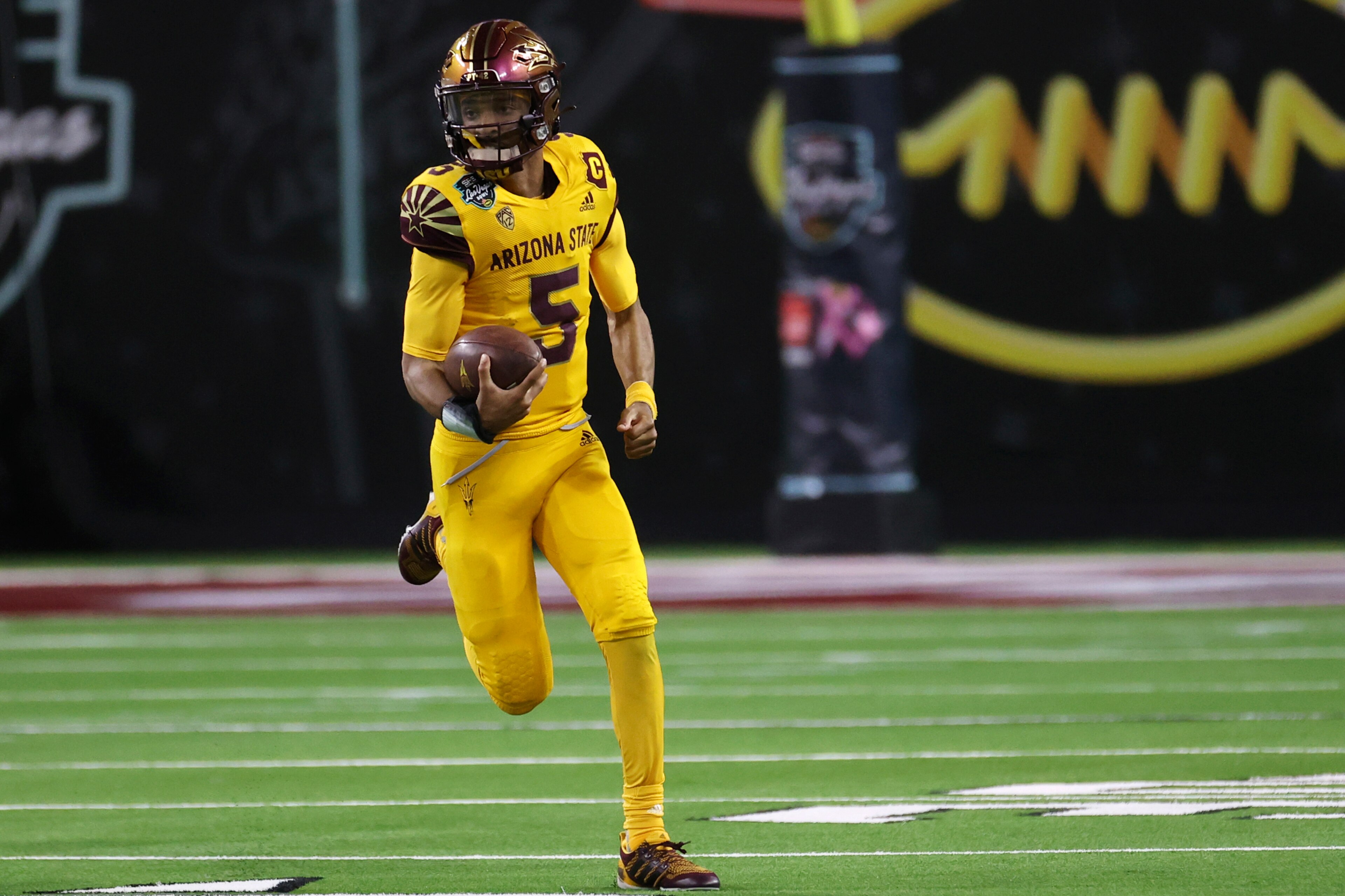 Arizona State quarterback Jayden Daniels (5) runs against Wisconsin during the second half of the Las Vegas Bowl NCAA college football game Thursday, Dec. 30, 2021, in Las Vegas. (AP Photo/L.E. Baskow)