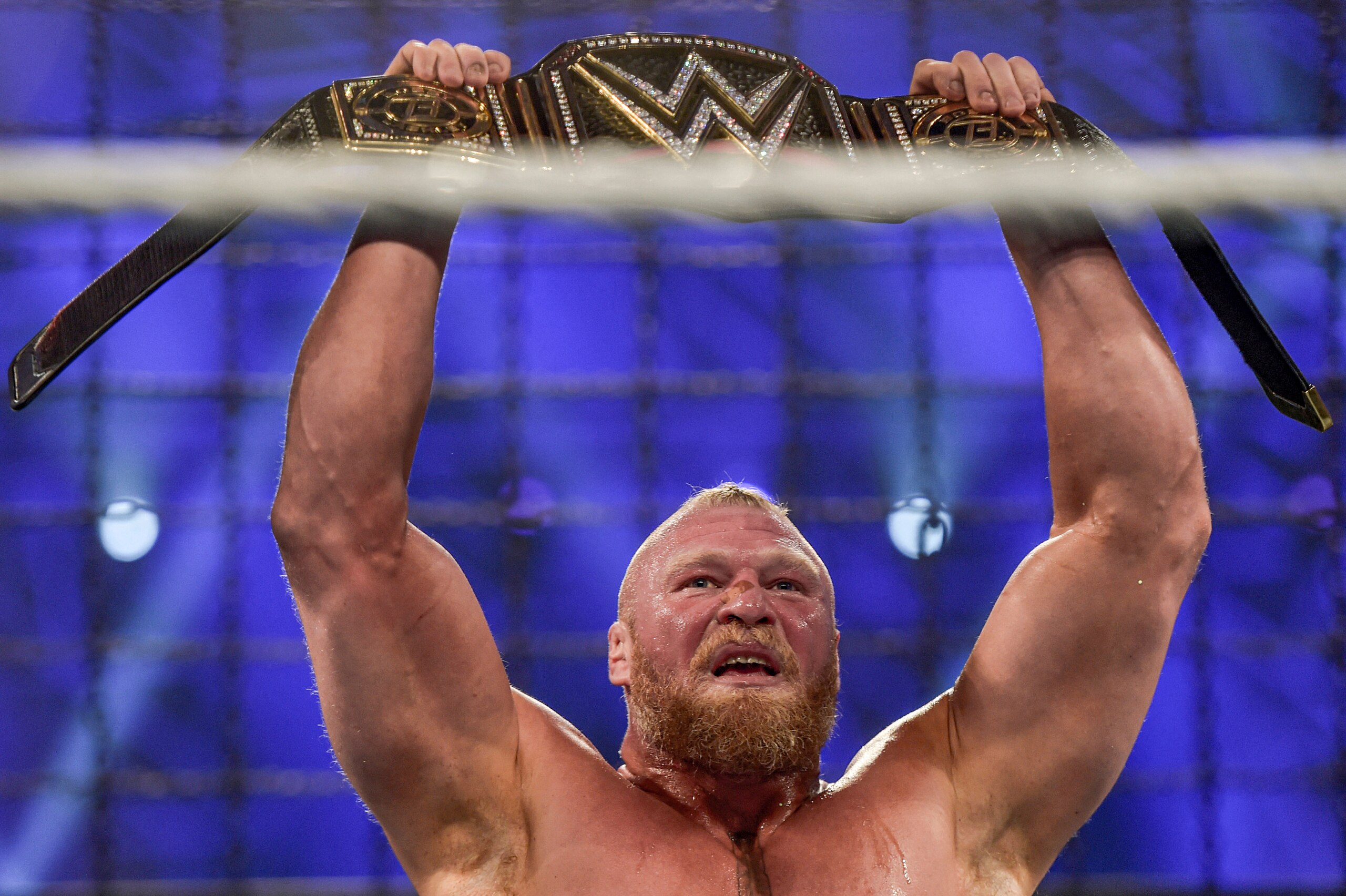 Brock Lesnar holds up the championship belt after winning the 2022 World Wrestling Entertainment (WWE) Elimination Chamber at the Jeddah Super Dome in Saudi Arabia's Red Sea coastal city of Jeddah on February 19, 2022. (Photo by Amer HILABI / AFP) (Photo by AMER HILABI/AFP via Getty Images)