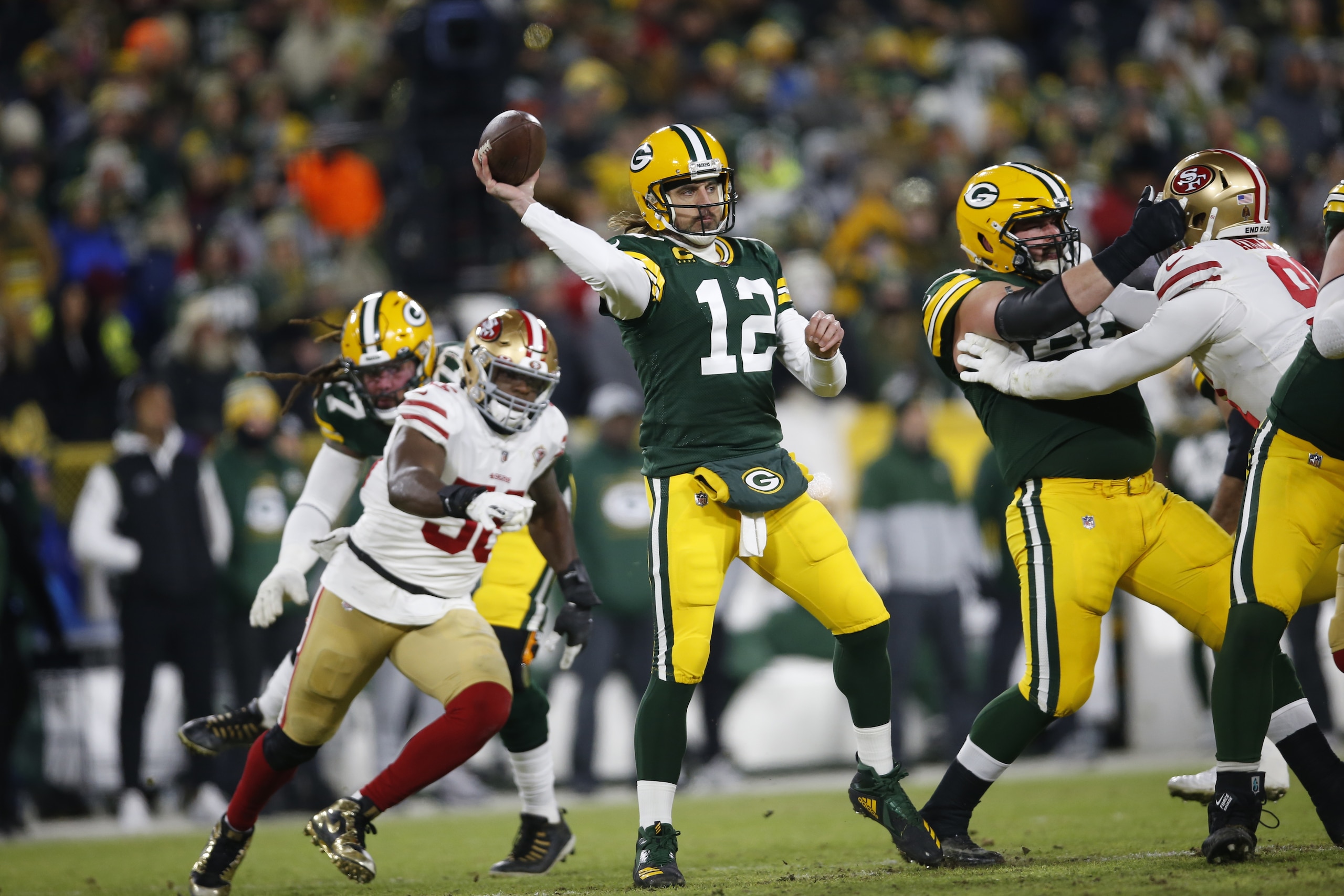 GREEN BAY, WISCONSIN - JANUARY 22: Aaron Rodgers #12 of the Green Bay Packers passes during the game against the San Francisco 49ers in the NFC Divisional Playoff game at Lambeau Field on January 22, 2022 in Green Bay, Wisconsin. The 49ers defeated the Packers 13-10. (Photo by Michael Zagaris/San Francisco 49ers/Getty Images)
