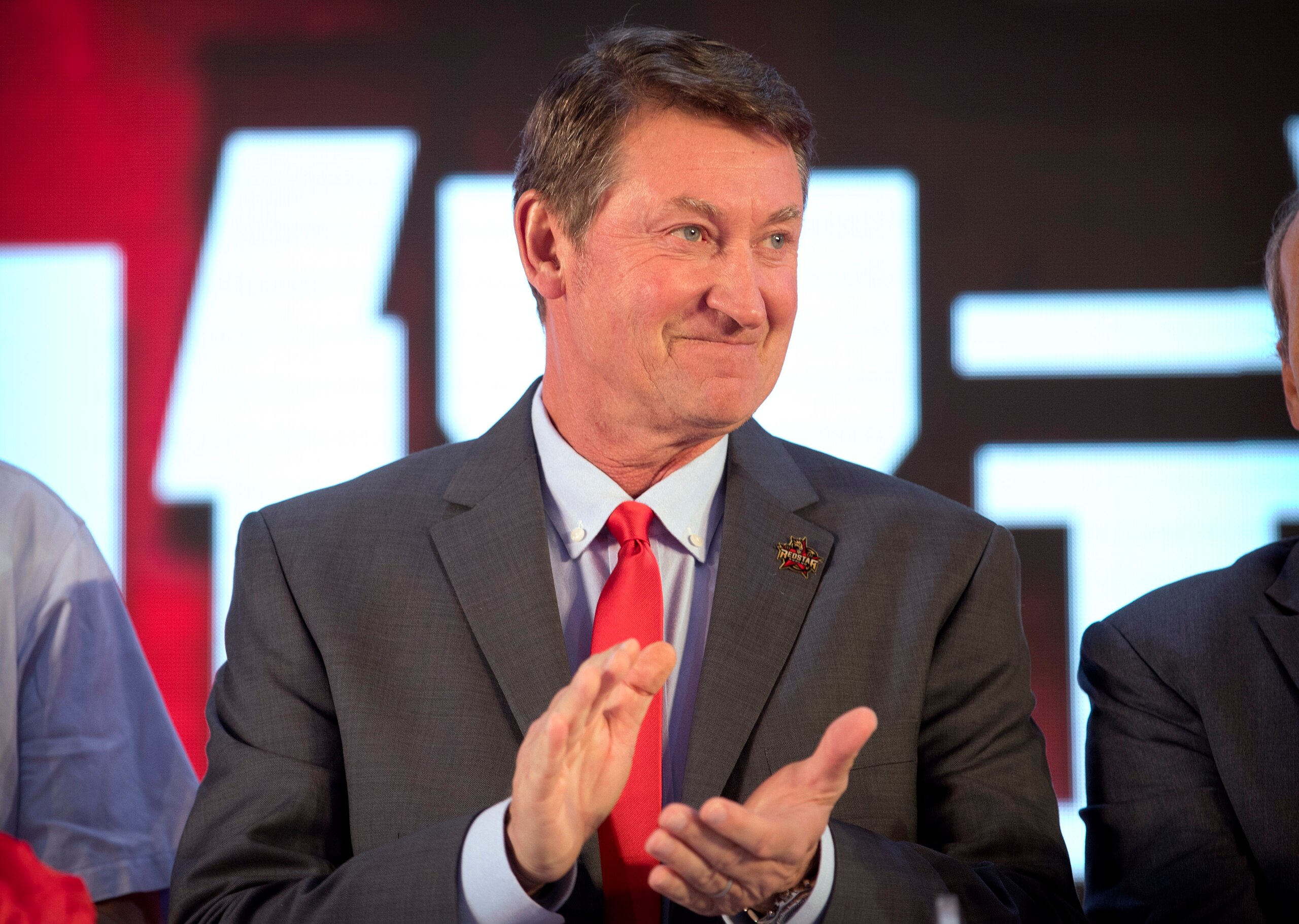 Former NHL hockey player Wayne Gretzky applauds during a promotional event for the Beijing Kunlun Red Star hockey team in his role as global ambassador for the team, part of the Russia-based Kontinental Hockey League, in Beijing, Thursday, Sept. 13, 2018. Gretzky says the NHL should again allow its players to compete in the Winter Olympics because sending the world's top hockey players is "always much better for everyone." (AP Photo/Mark Schiefelbein) Former NHL hockey player Wayne Gretzky applauds during a promotional event for the Beijing Kunlun Red Star hockey team in his role as global ambassador for the team, part of the Russia-based Kontinental Hockey League, in Beijing, Thursday, Sept. 13, 2018. Gretzky says the NHL should again allow its players to compete in the Winter Olympics because sending the world's top hockey players is "always much better for everyone." (AP Photo/Mark Schiefelbein)