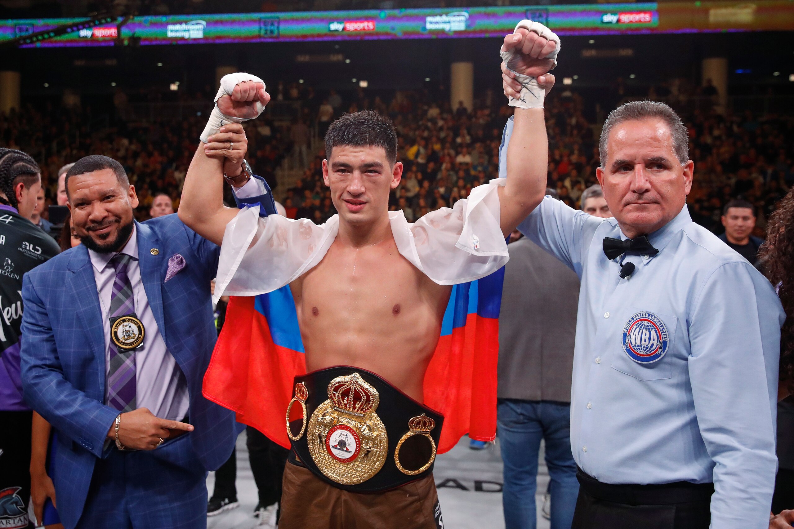 Dmitry Bivol, center, celebrates, after defeating Lenin Castillo during a WBA light heavyweight championship boxing bout Saturday, Oct. 12, 2019, in Chicago. (AP Photo/Kamil Krzaczynski)