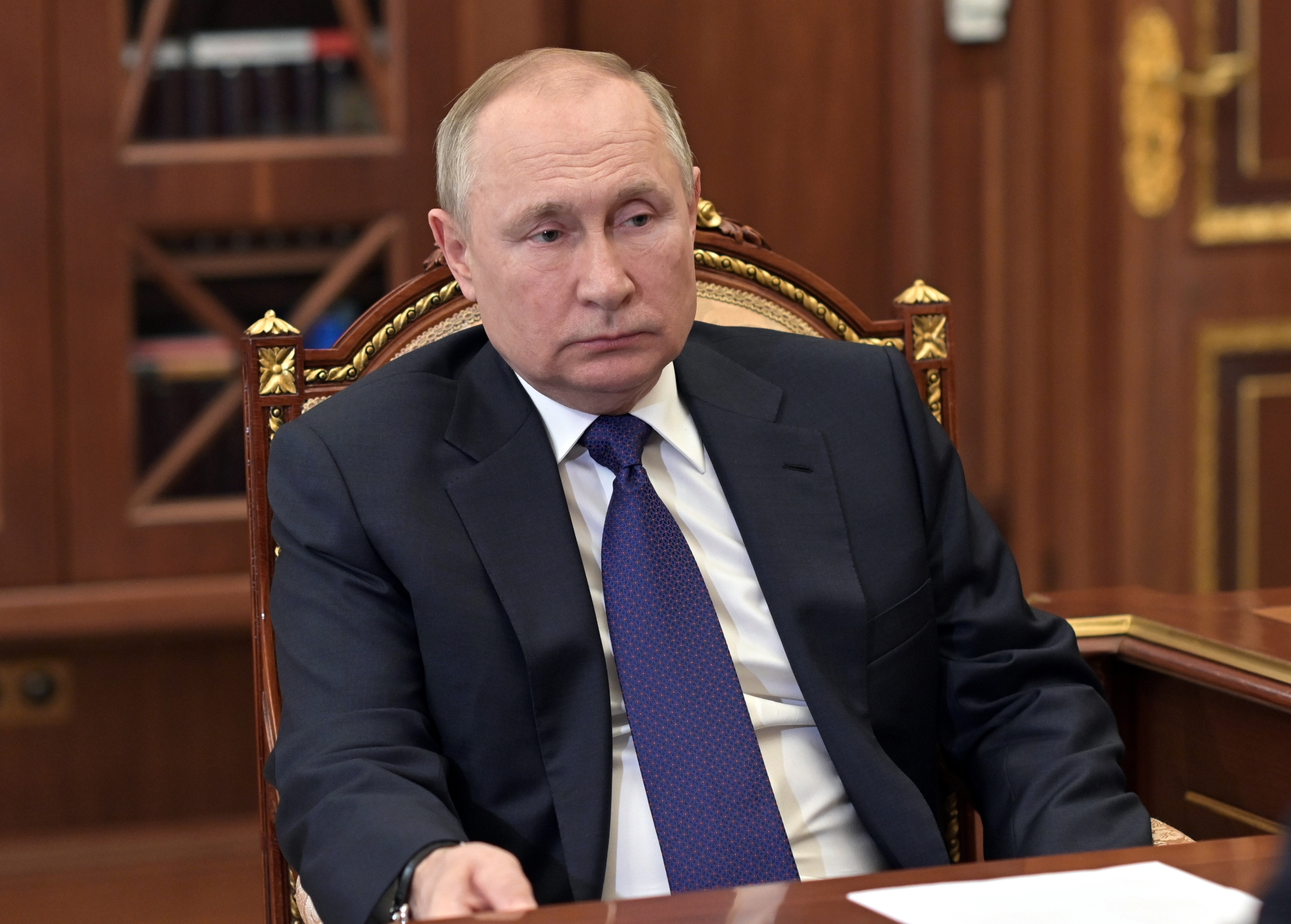 Russian President Vladimir Putin listens to St. Petersburg's governor Alexander Beglov during their meeting in the Kremlin in Moscow, Russia, Tuesday, March 1, 2022. (Alexei Nikolsky, Sputnik, Kremlin Pool Photo via AP)