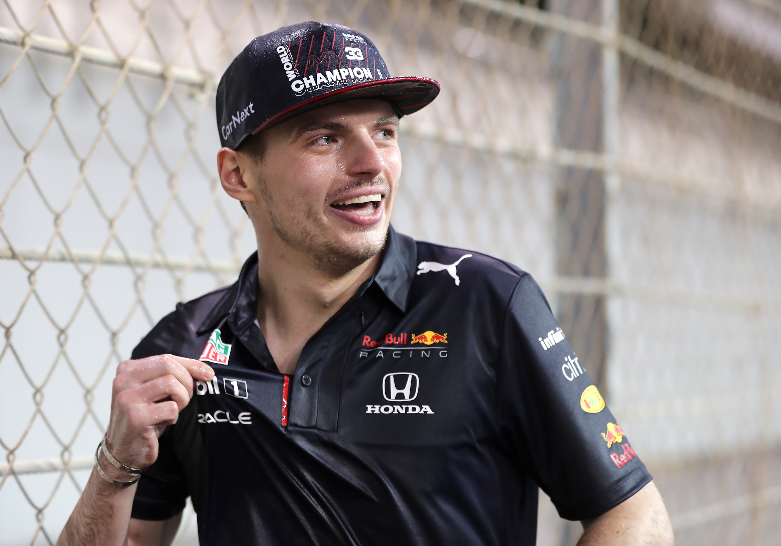 Red Bull driver Max Verstappen of the Netherlands walks away drenched after celebrating with his team in the pit lane after becoming F1 drivers world champion after winning the Formula One Abu Dhabi Grand Prix in Abu Dhabi, United Arab Emirates, Sunday, Dec. 12. 2021. The most dramatic Formula One season in years ended, of course, in one of the most dramatic finishes possible when Max Verstappen snatched the world championship away from Lewis Hamilton with a pass on the final lap of the Abu Dhabi GP. (AP Photo/Kamran Jebreili)