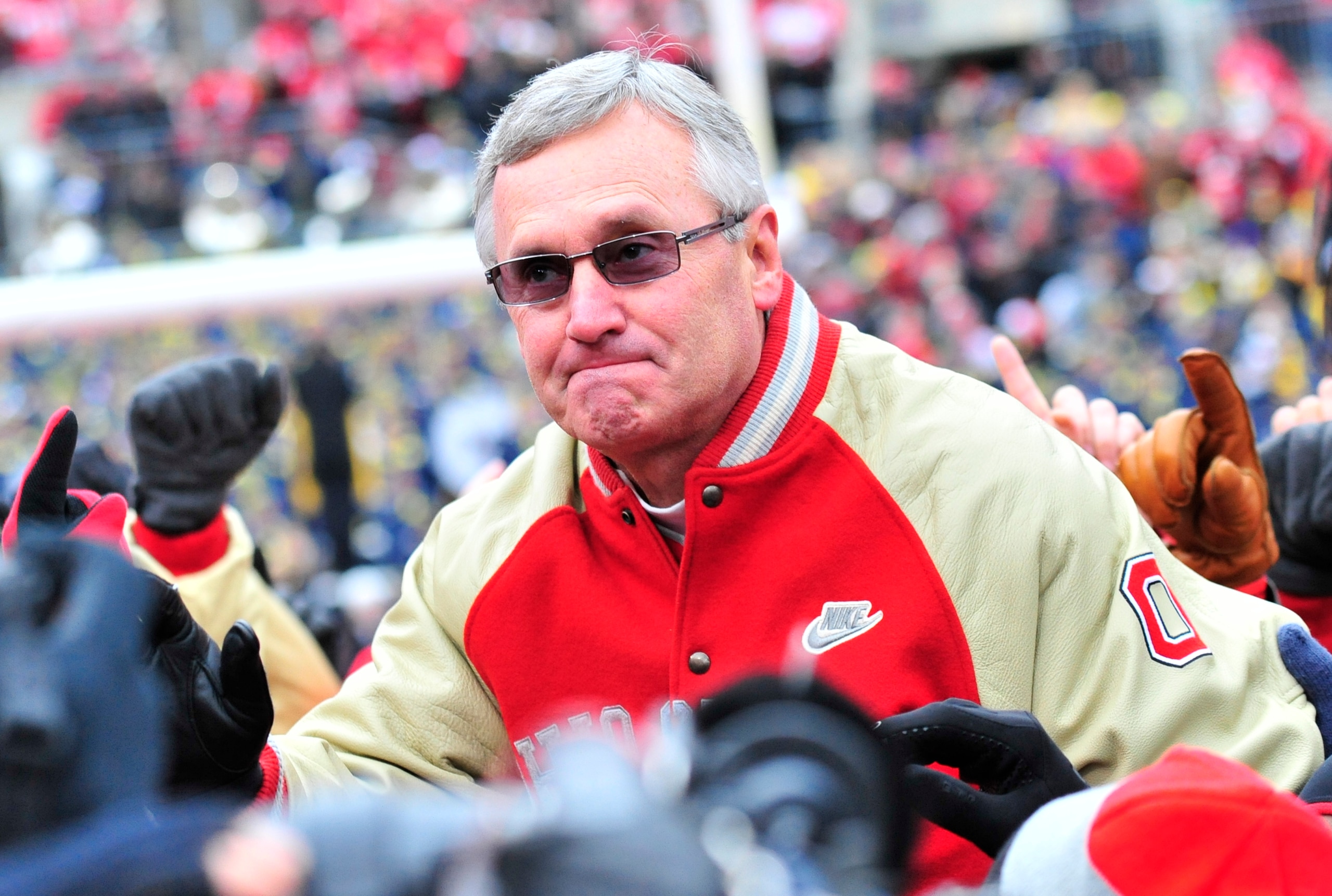 COLUMBUS, OHIO - NOVEMBER 24, 2012: Former head coach Jim Tressel of the Ohio State Buckeyes reacts to being carried off the field on the shoulders of his former players during a game between the Ohio State Buckeyes and Michigan Wolverines at Ohio Stadium in Columbus, Ohio. The Buckeyes won 26-21. (Photo by David Dermer/Diamond Images/Getty Images) COLUMBUS, OHIO - NOVEMBER 24, 2012: Former head coach Jim Tressel of the Ohio State Buckeyes reacts to being carried off the field on the shoulders of his former players during a game between the Ohio State Buckeyes and Michigan Wolverines at Ohio Stadium in Columbus, Ohio. The Buckeyes won 26-21. (Photo by David Dermer/Diamond Images/Getty Images)