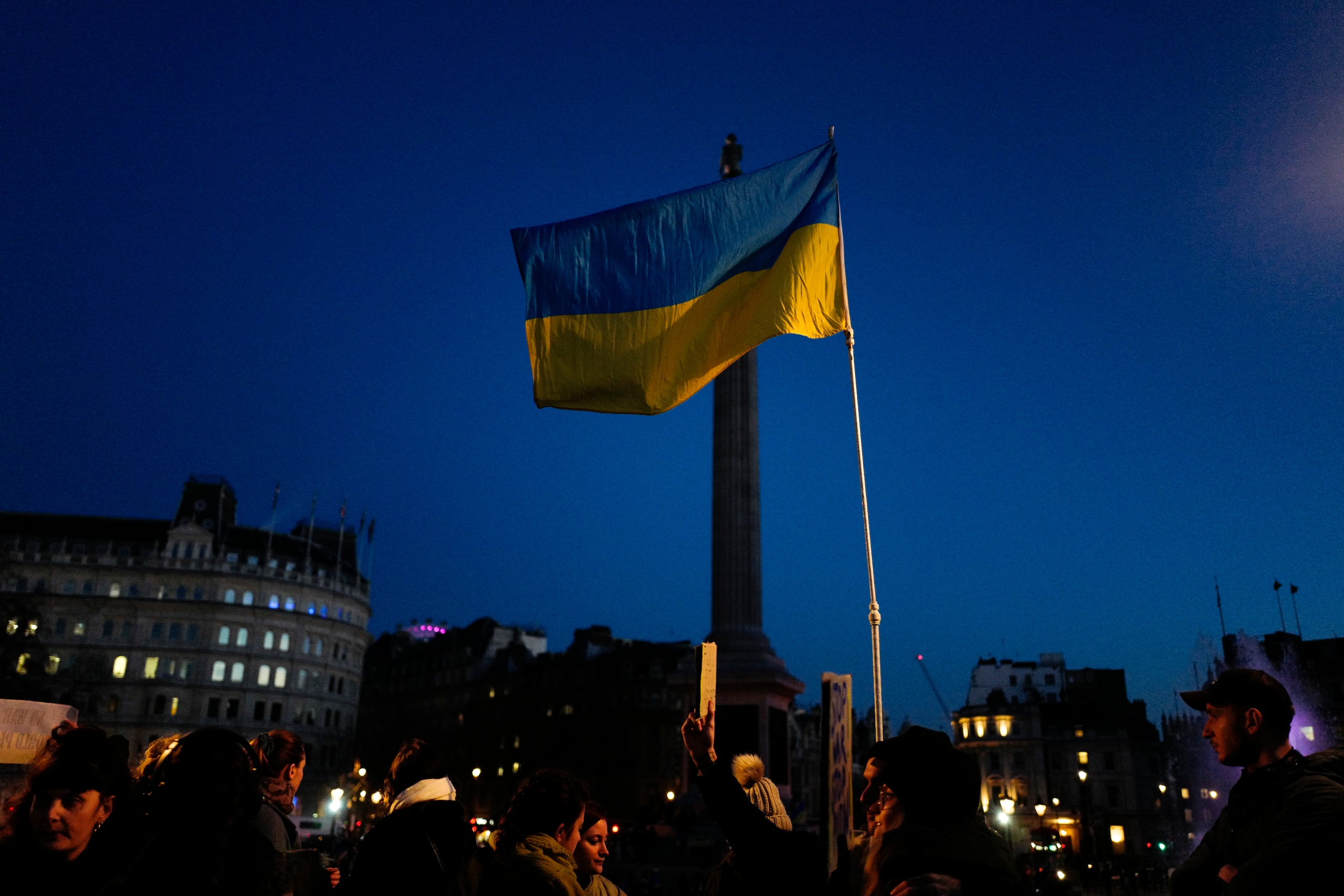 A Ukraine flag is held high during a protest in Trafalgar Square, in London, Sunday, Feb. 27, 2022. A Ukrainian official says street fighting has broken out in Ukraine's second-largest city of Kharkiv. Russian troops also put increasing pressure on strategic ports in the country's south following a wave of attacks on airfields and fuel facilities elsewhere that appeared to mark a new phase of Russia's invasion. (AP Photo/Alberto Pezzali)