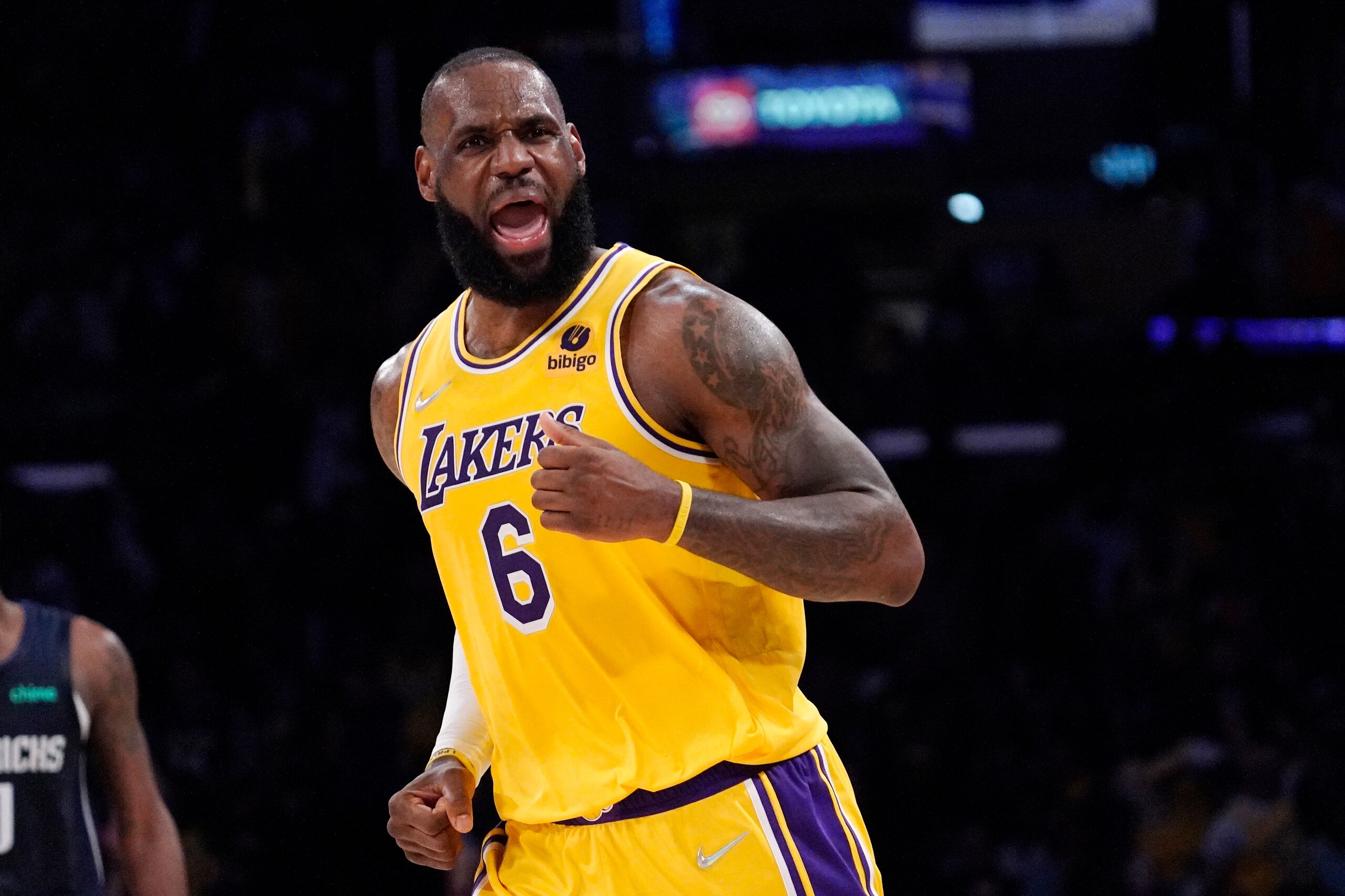 Los Angeles Lakers forward LeBron James celebrates after scoring during the second half of an NBA basketball game against the Dallas Mavericks Tuesday, March 1, 2022, in Los Angeles. (AP Photo/Mark J. Terrill)