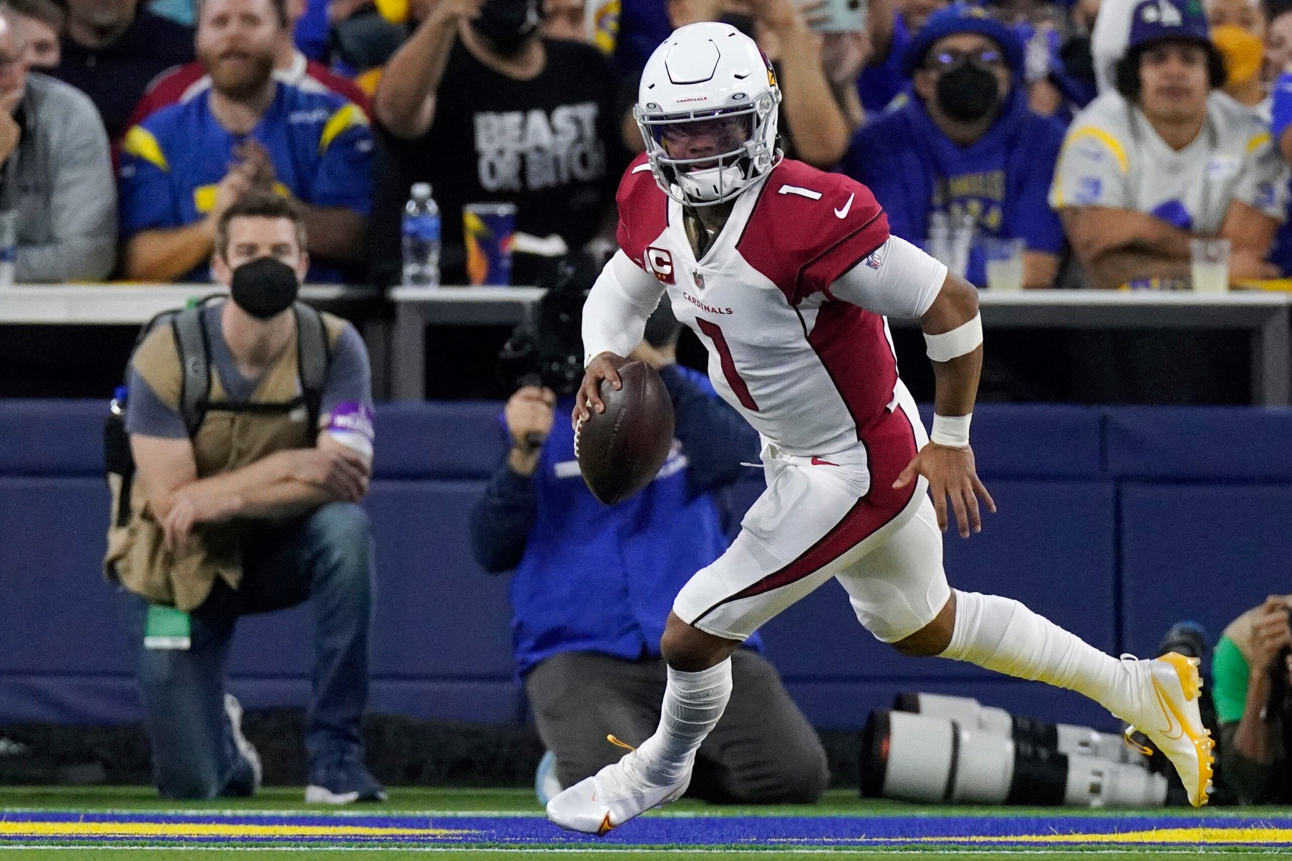Arizona Cardinals quarterback Kyler Murray (1) scrambles while pressured by Los Angeles Rams defensive end Greg Gaines (91) during the first half of an NFL wild-card playoff football game in Inglewood, Calif., Monday, Jan. 17, 2022. (AP Photo/Mark J. Terrill)