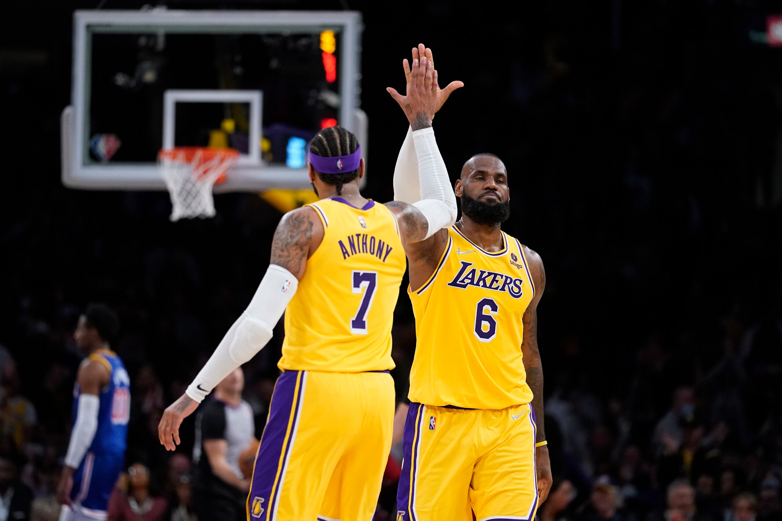 Los Angeles Lakers forward Carmelo Anthony (7) high-fives forward LeBron James (6) during the second half of an NBA basketball game against the Golden State Warriors in Los Angeles, Saturday, March 5, 2022. (AP Photo/Ashley Landis)