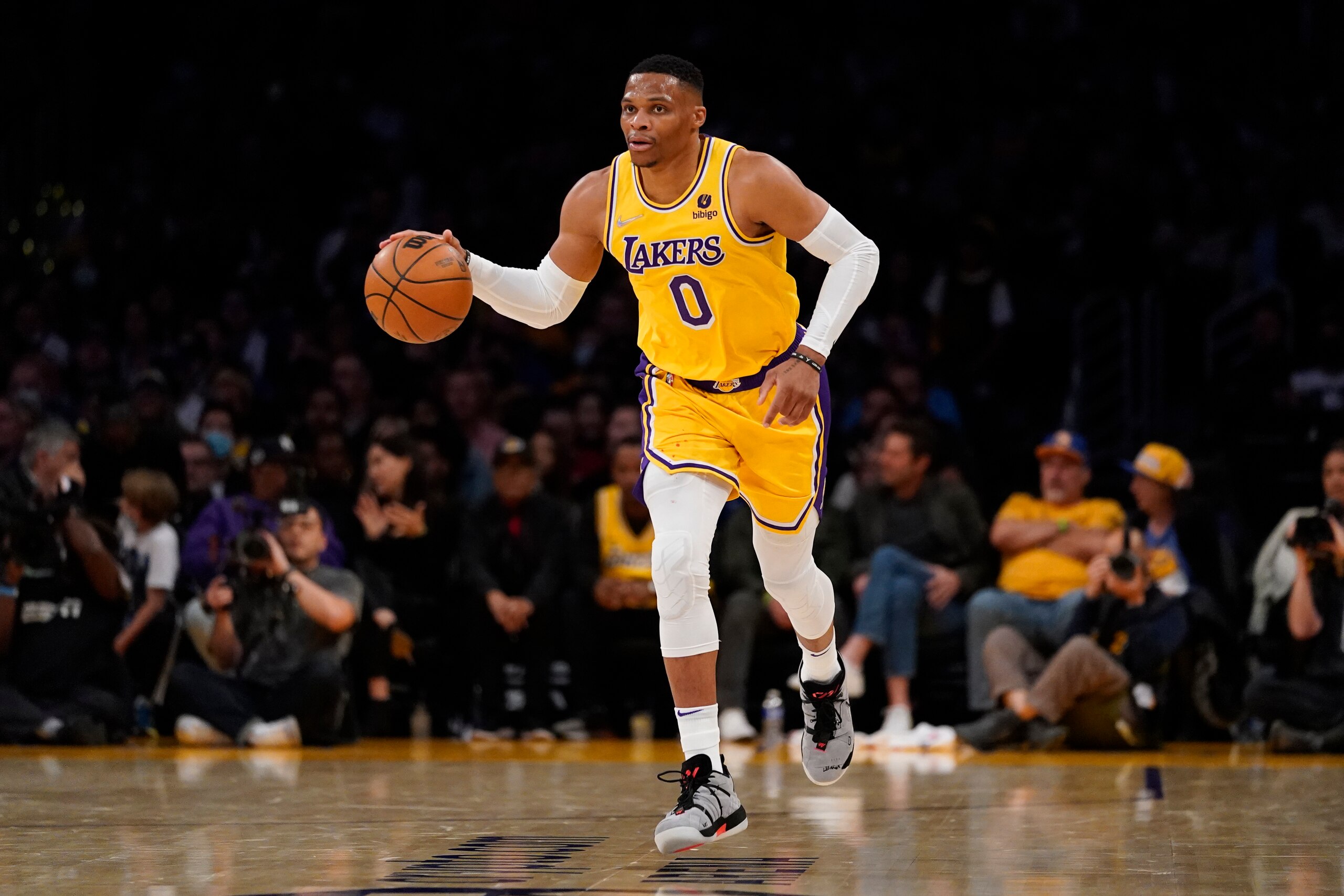 Los Angeles Lakers guard Russell Westbrook (0) controls the ball during the first half of an NBA basketball game against the Golden State Warriors in Los Angeles, Saturday, March 5, 2022. (AP Photo/Ashley Landis)