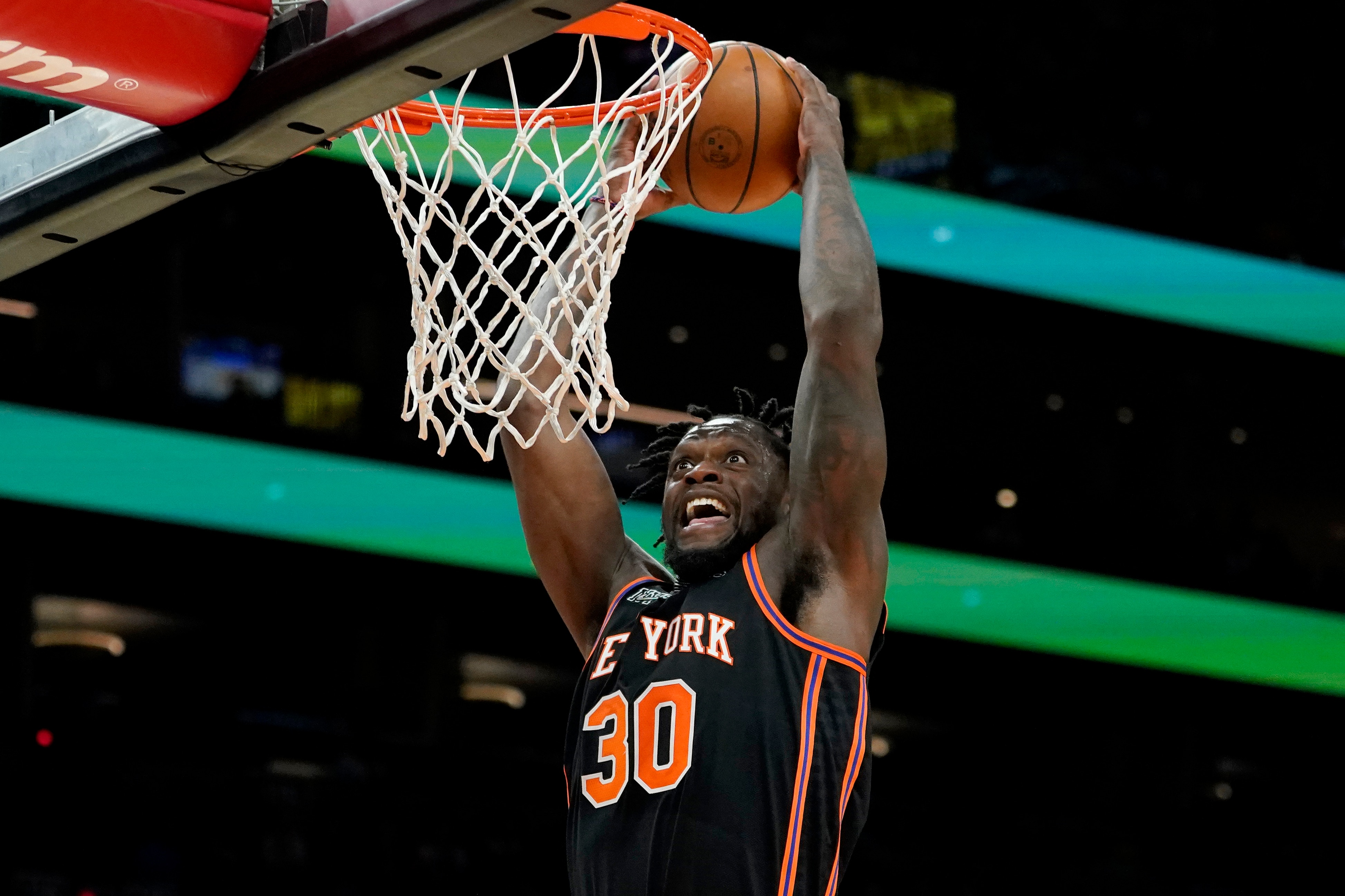 New York Knicks forward Julius Randle (30) duns against the Phoenix Suns during the first half of an NBA basketball game, Friday, March 4, 2022, in Phoenix. (AP Photo/Matt York)