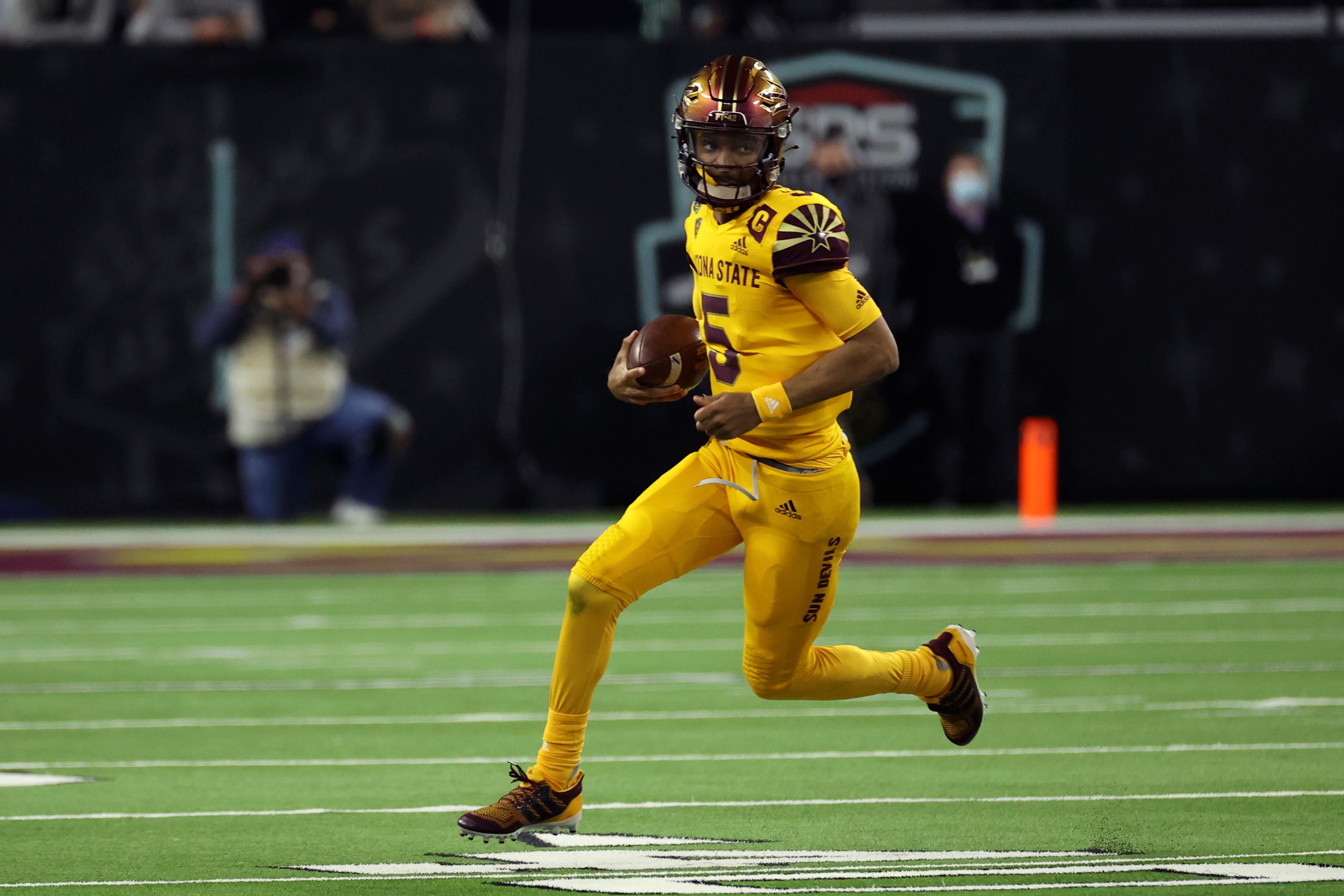Arizona State quarterback Jayden Daniels (5) runs against Wisconsin during the first half of the Las Vegas Bowl NCAA college football game Thursday, Dec. 30, 2021, in Las Vegas. (AP Photo/L.E. Baskow)